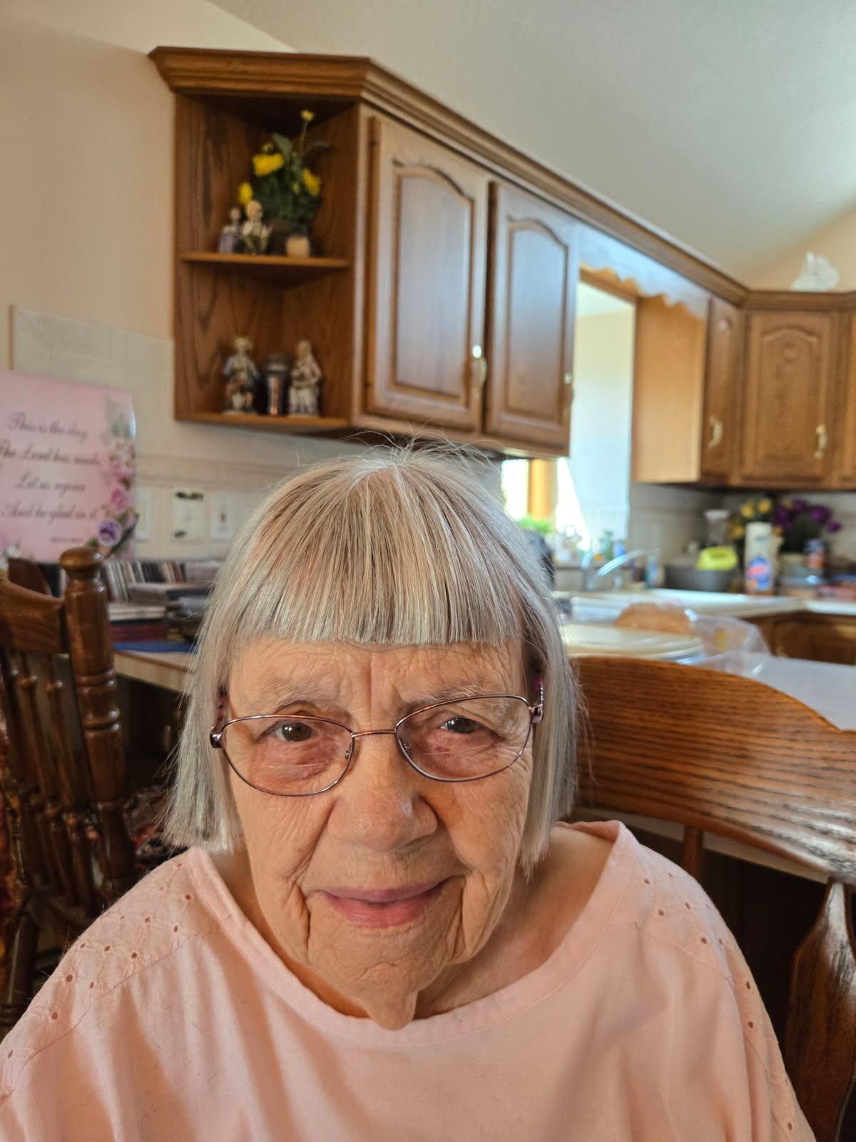 A woman sitting in a kitchen