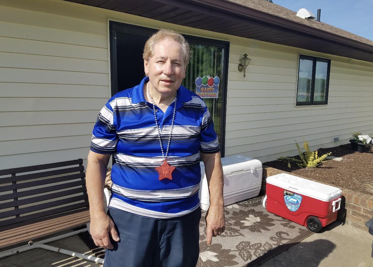 A man standing outside of a house