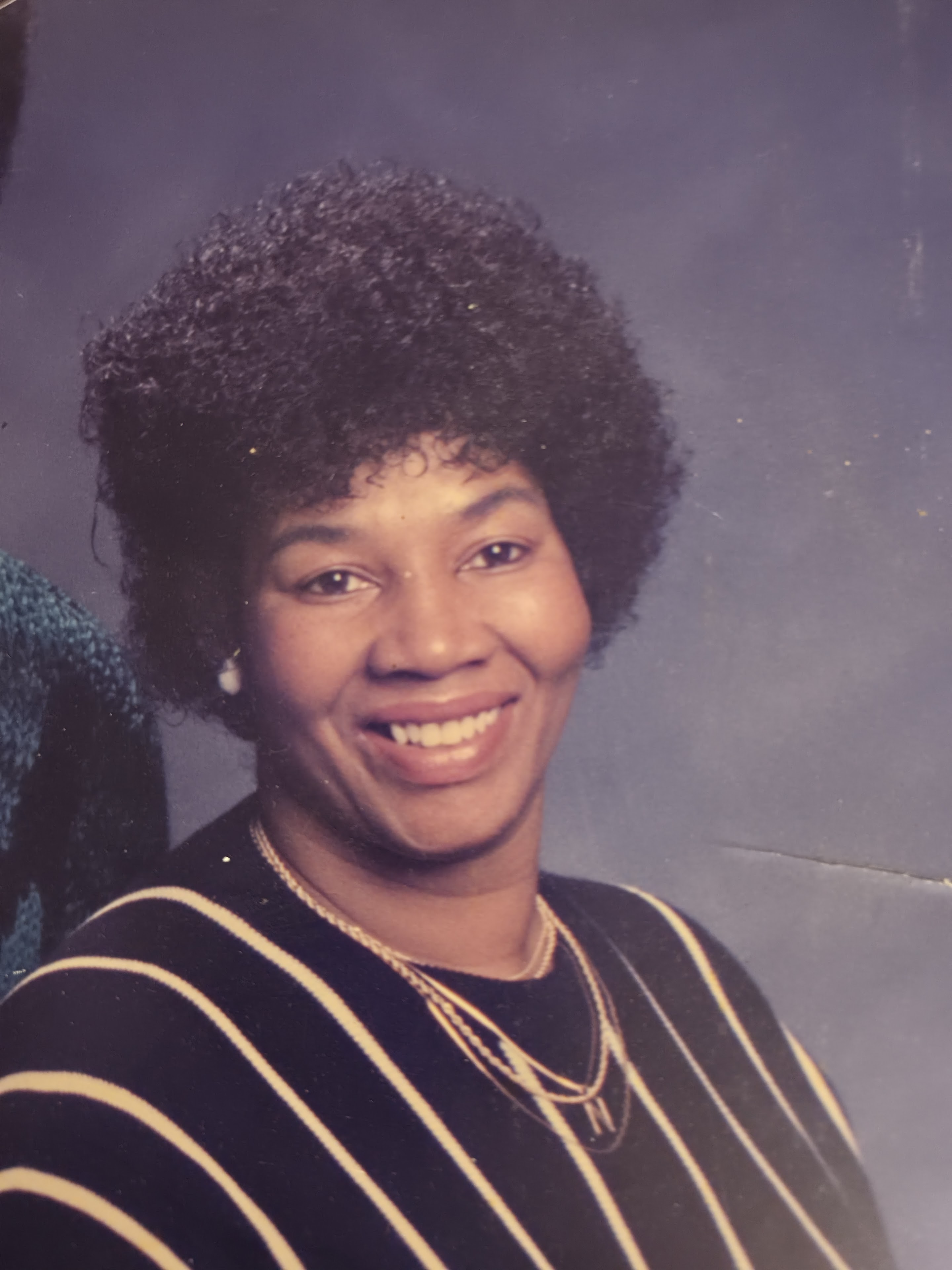 A woman with curly hair smiling