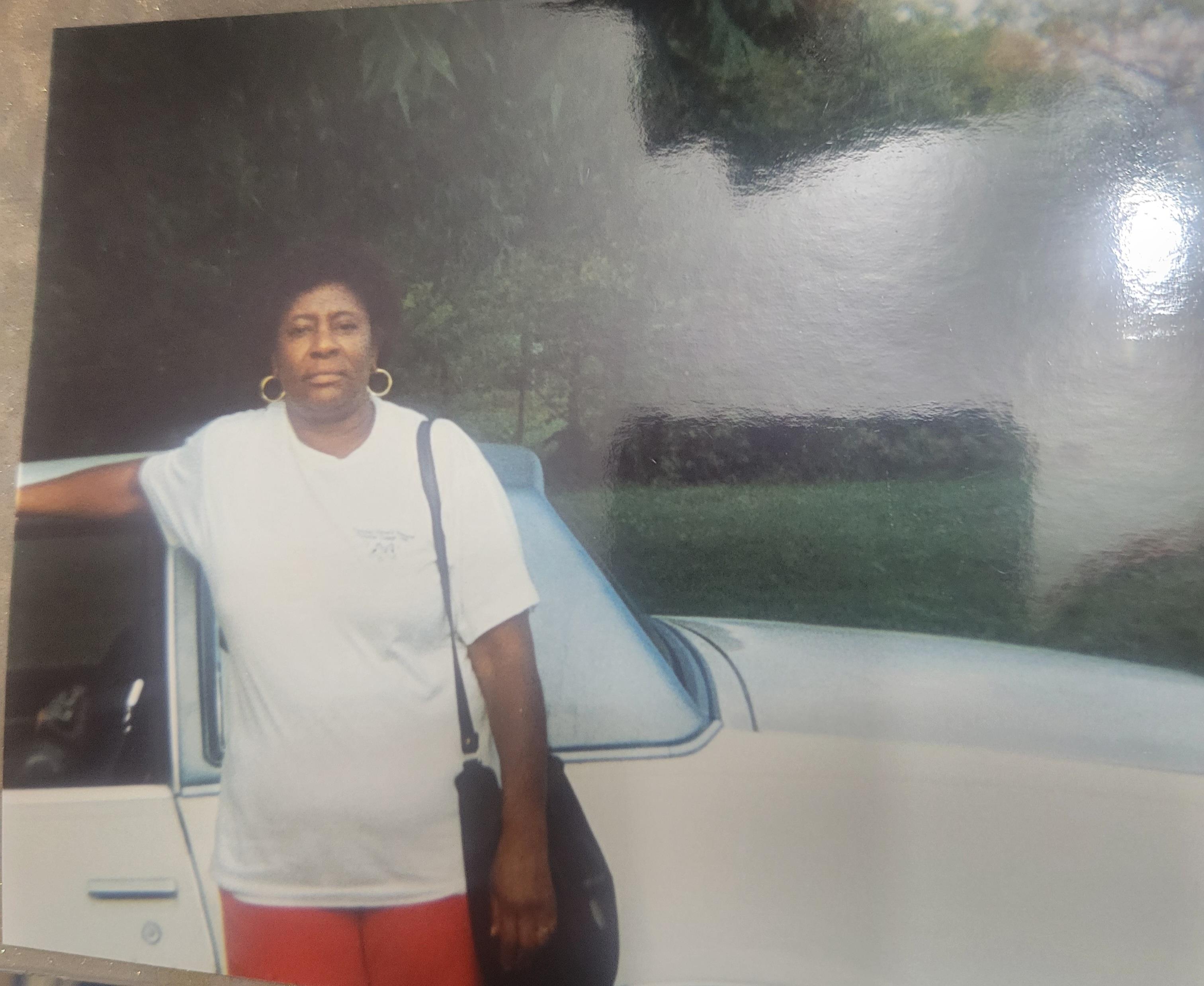 A woman standing next to a car