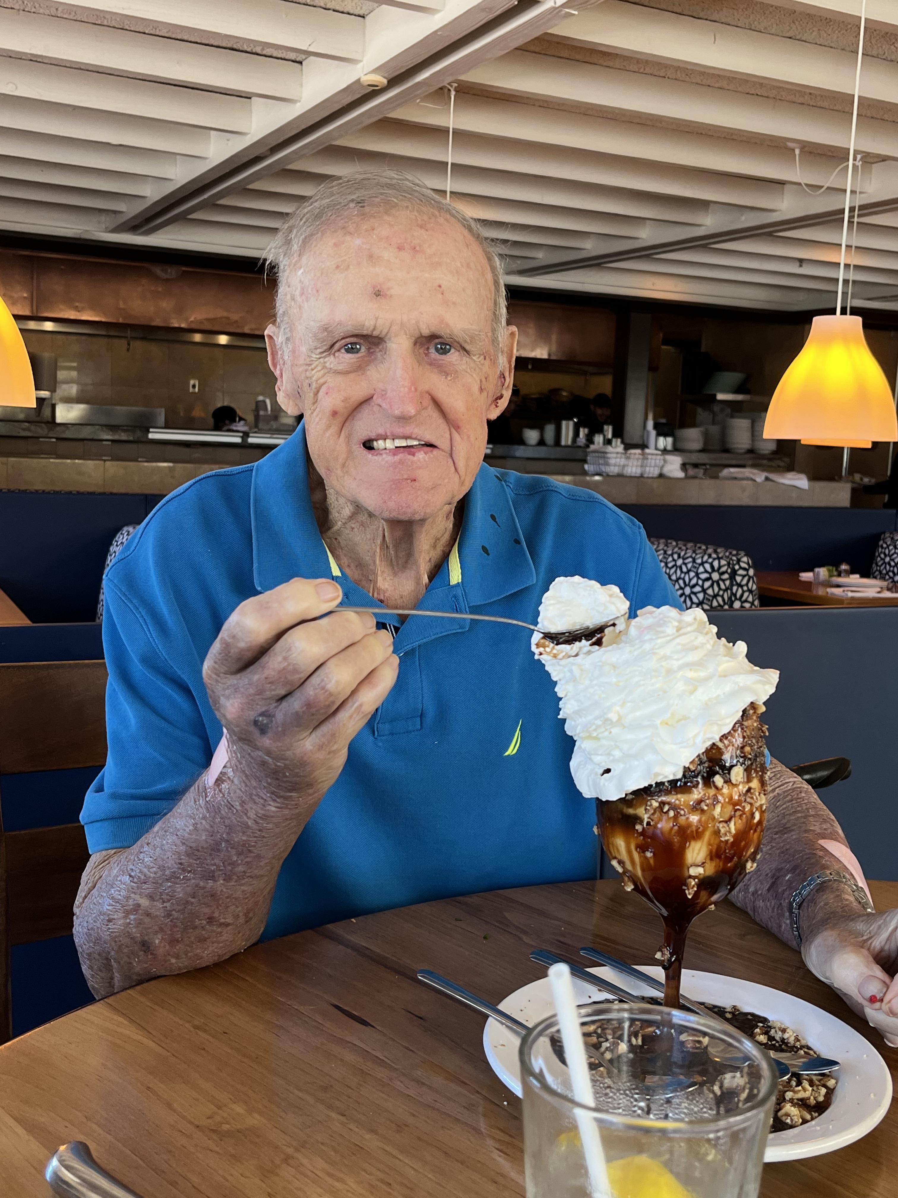 An old man eating a dessert
