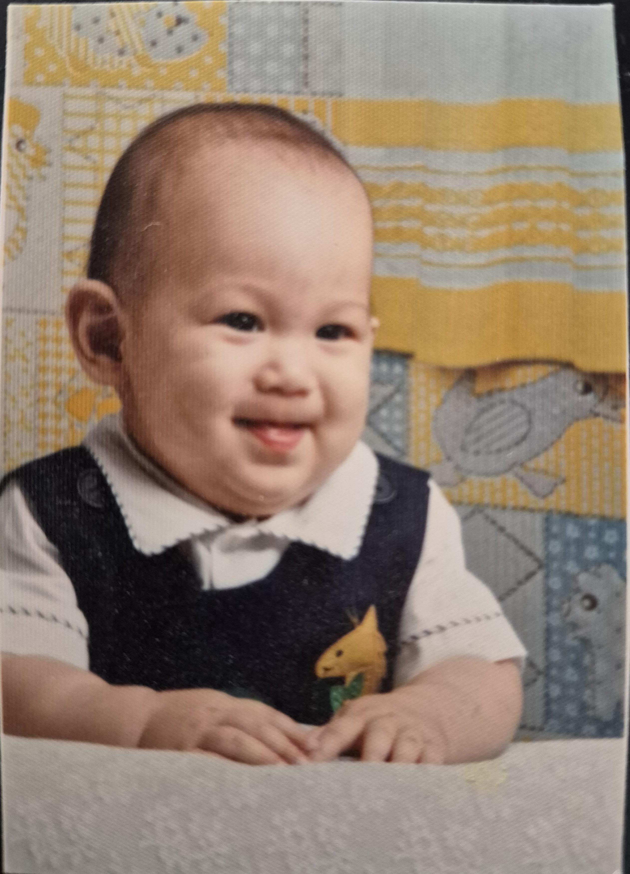 A baby smiling at the camera