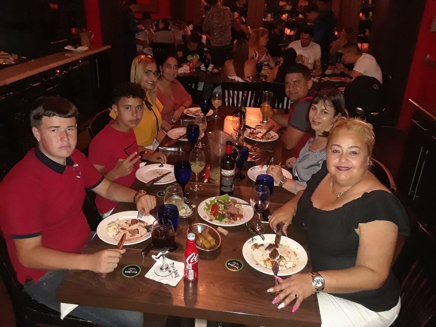 A group of people sitting at a table eating food