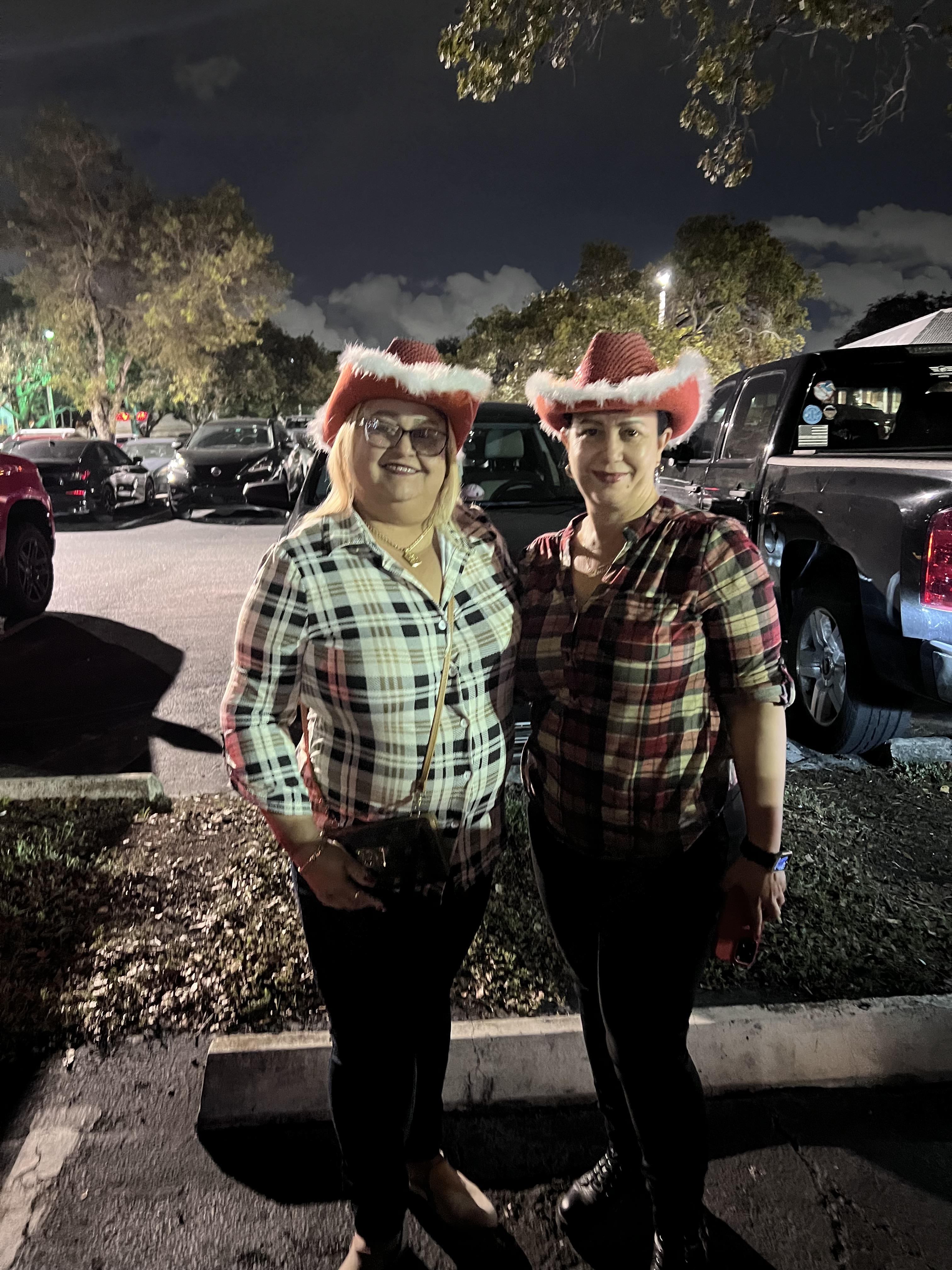 Two women wearing hats and shirts