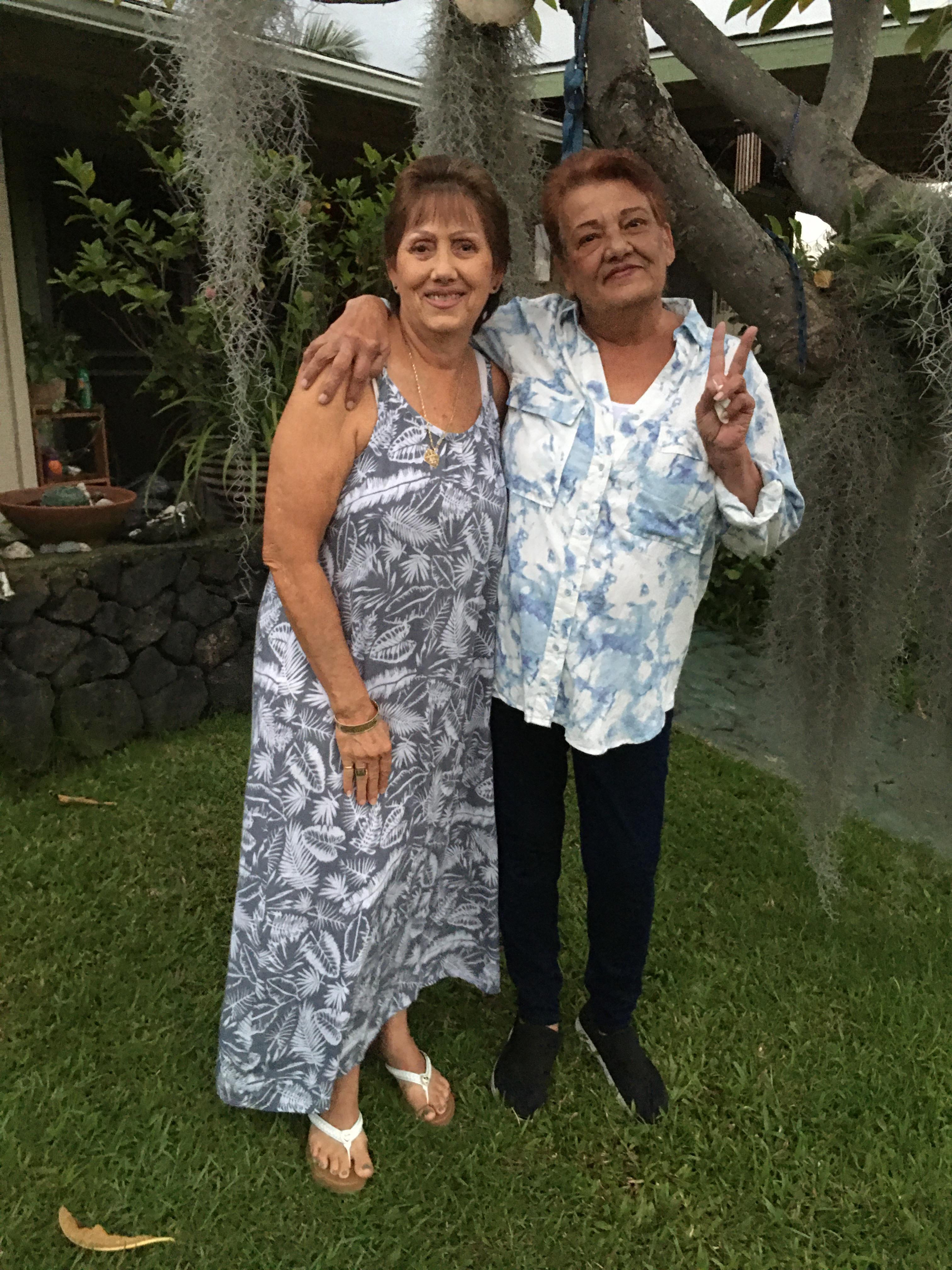 Two women standing in a yard