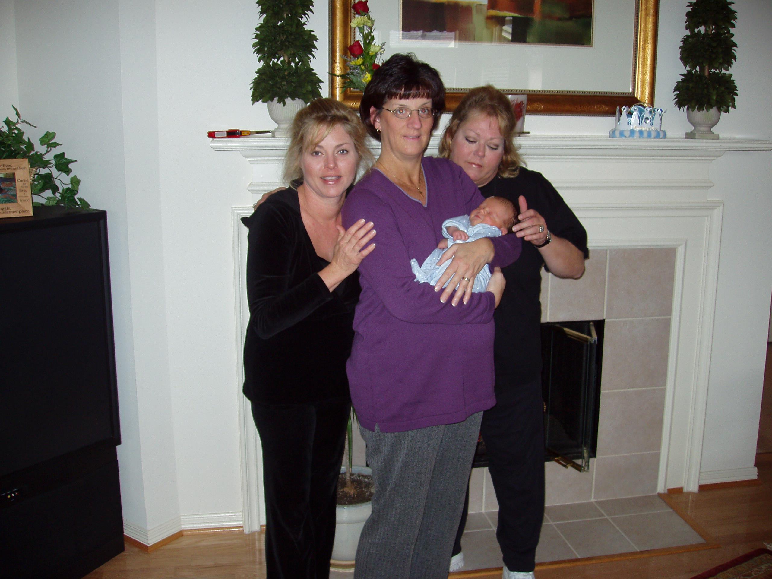 A group of women holding a baby