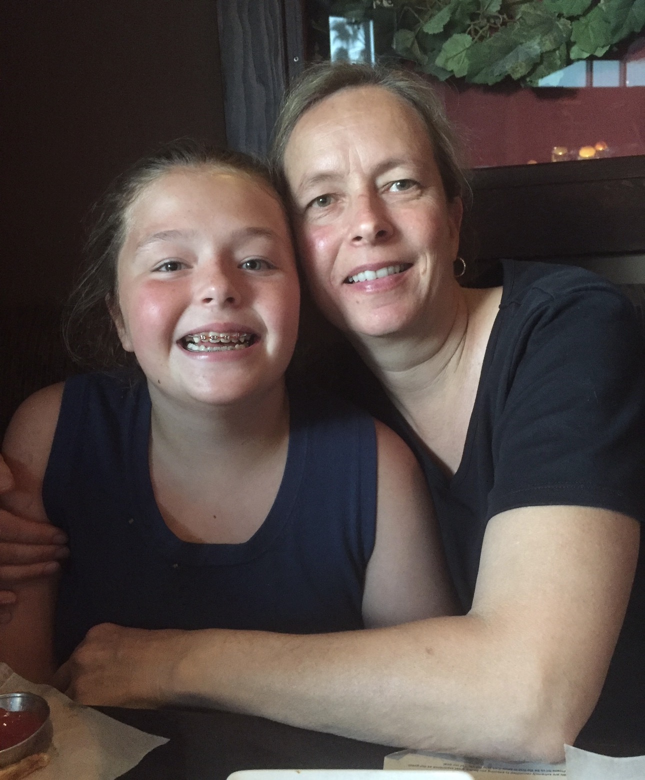 A woman and a girl posing for a picture