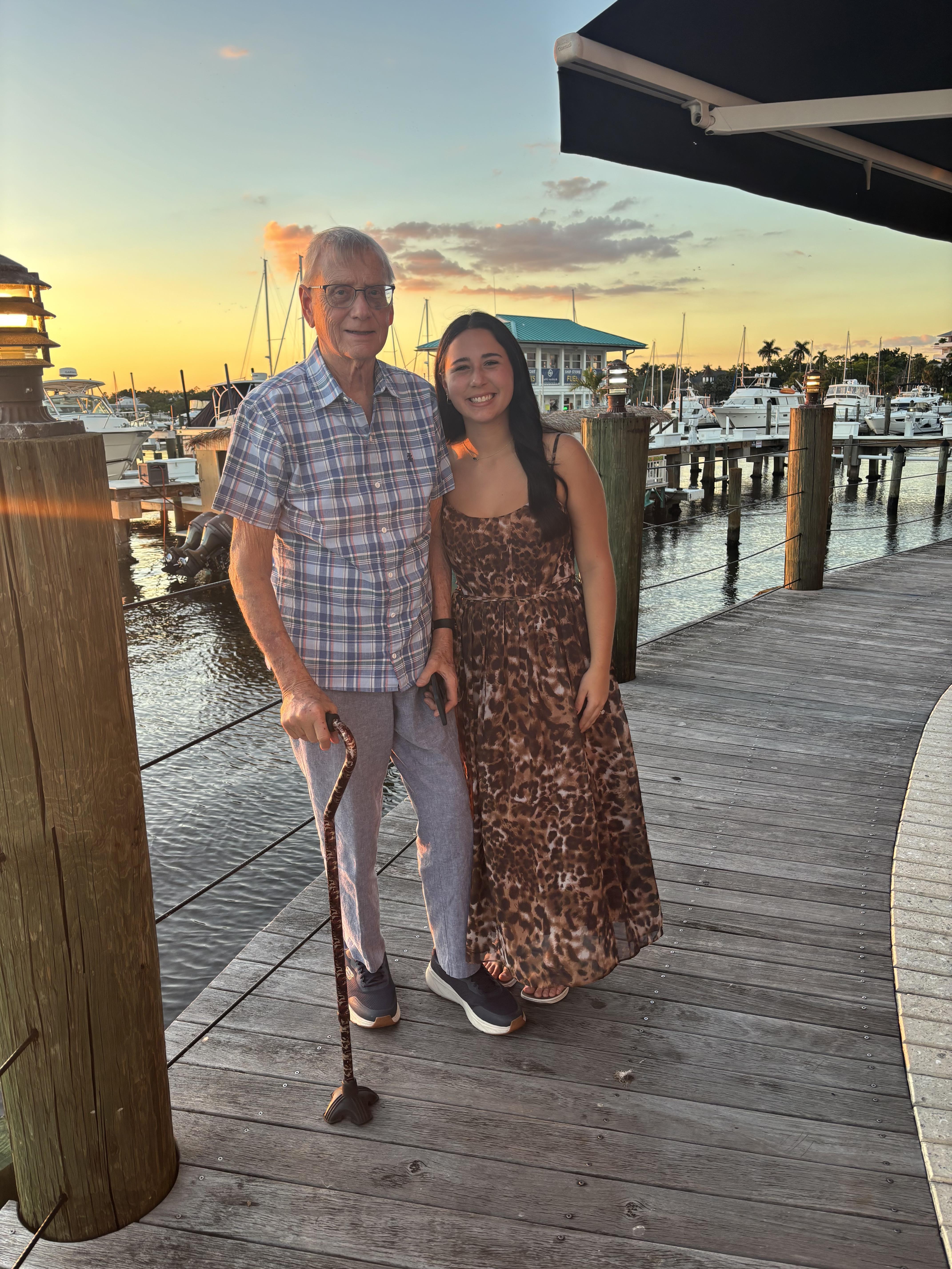 A man and woman standing on a dock