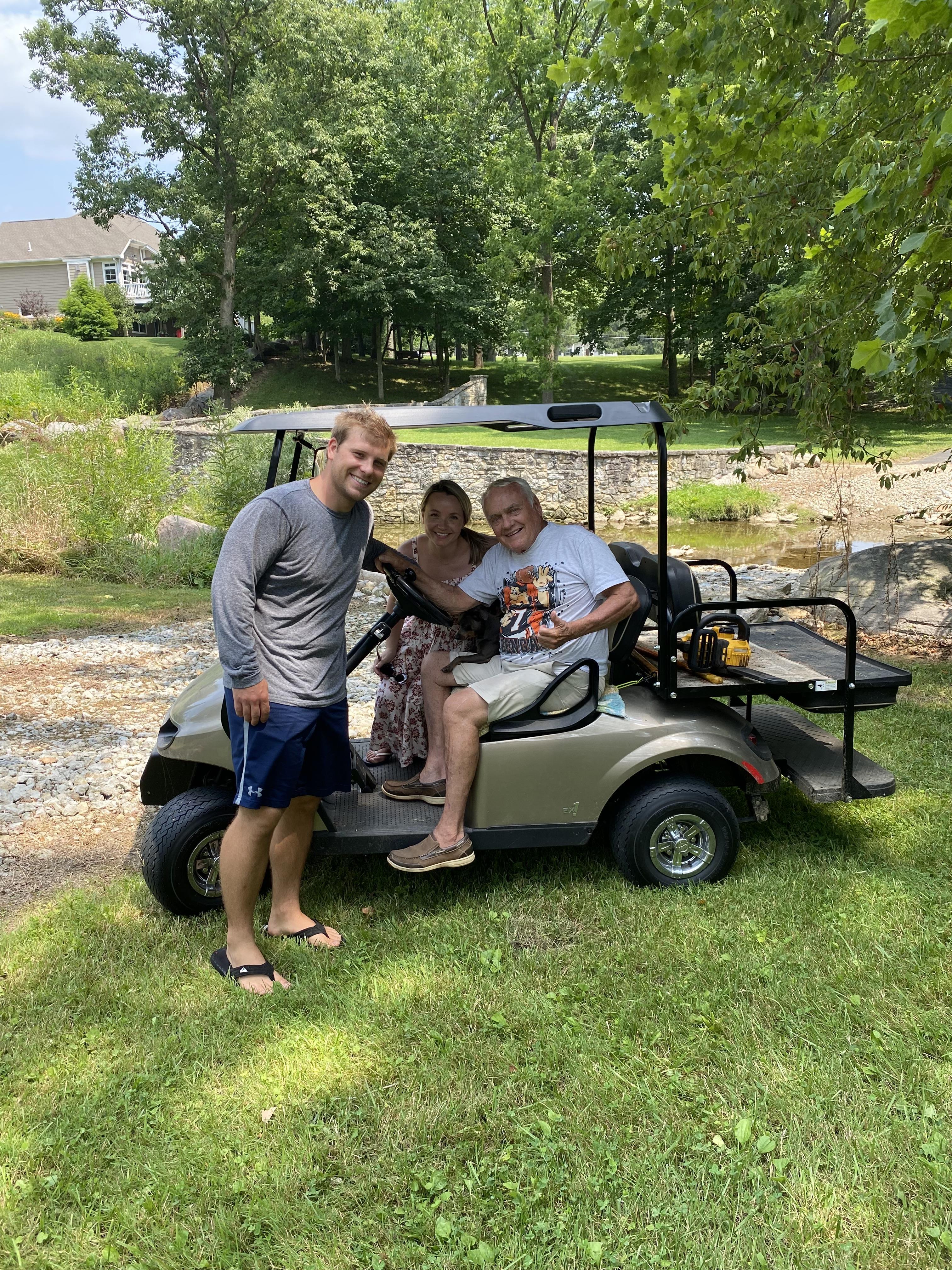 A group of people in a golf cart
