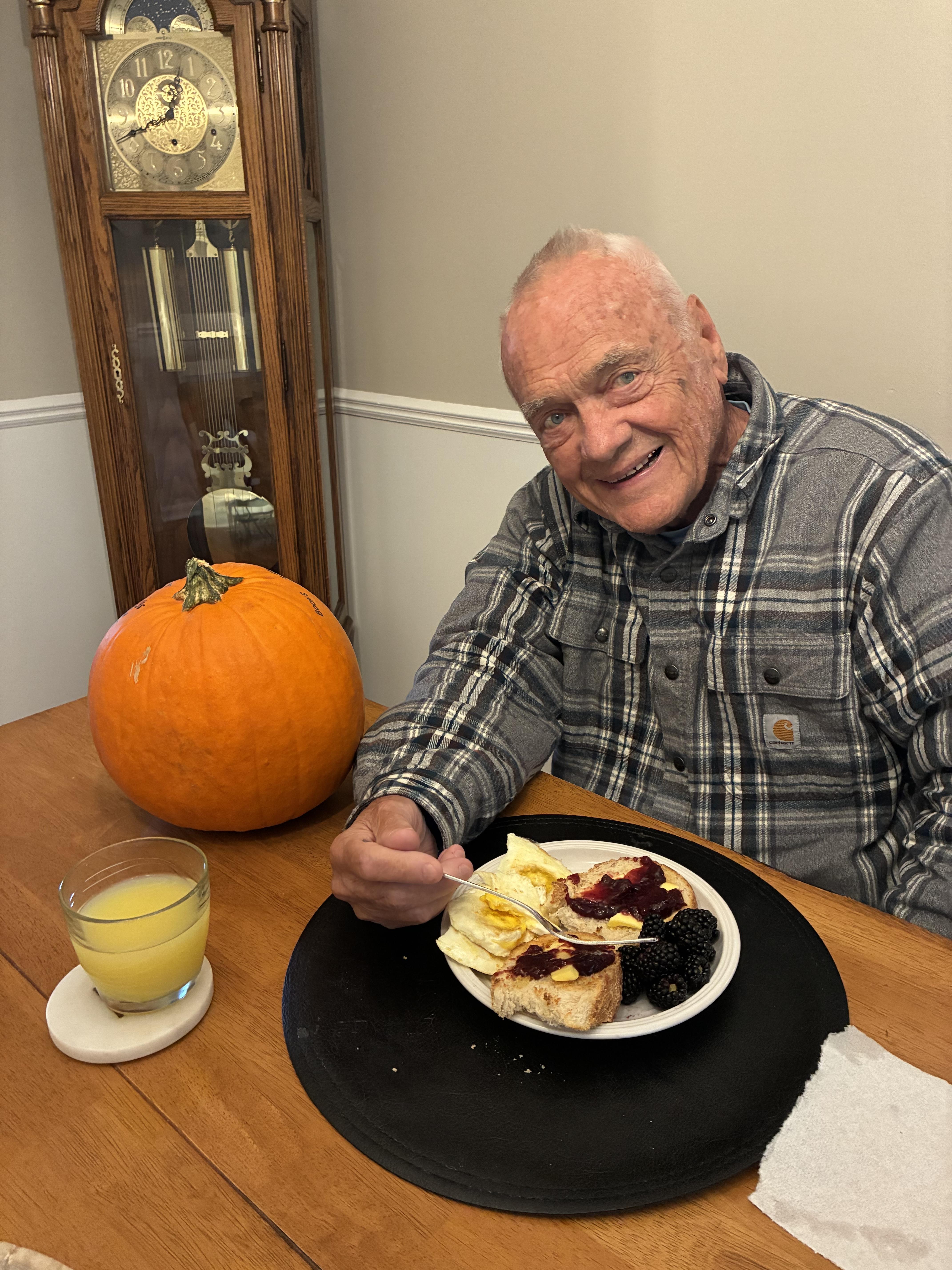 A man sitting at a table with a plate of food