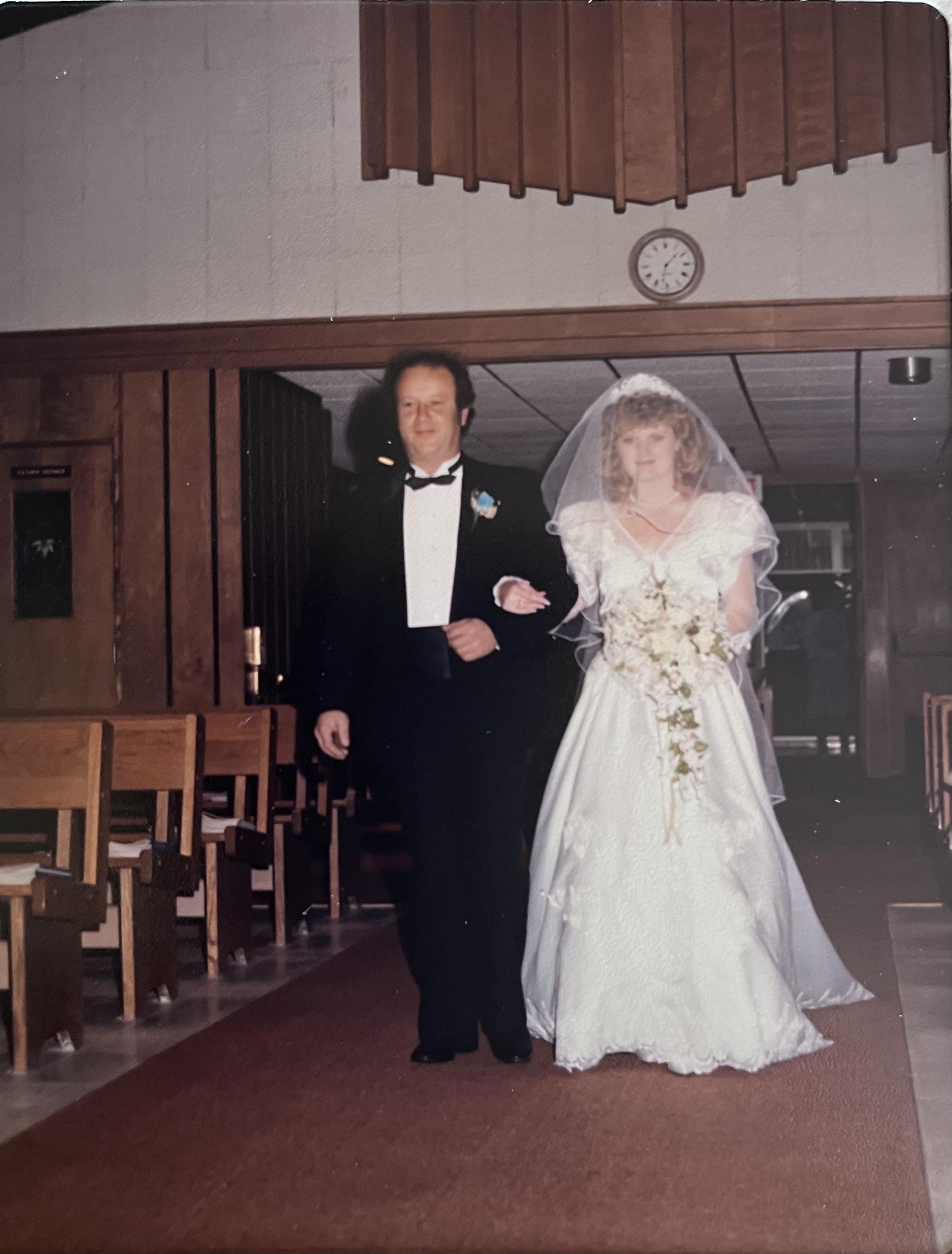 A man and woman walking down a aisle