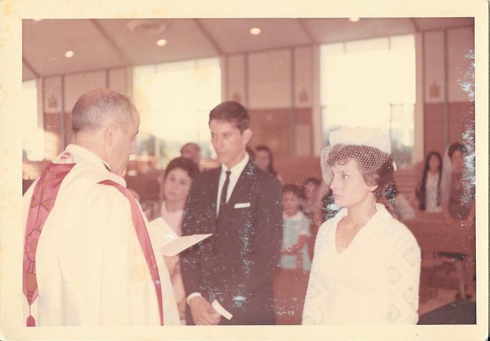 A man in a white robe talking to a woman in a white robe