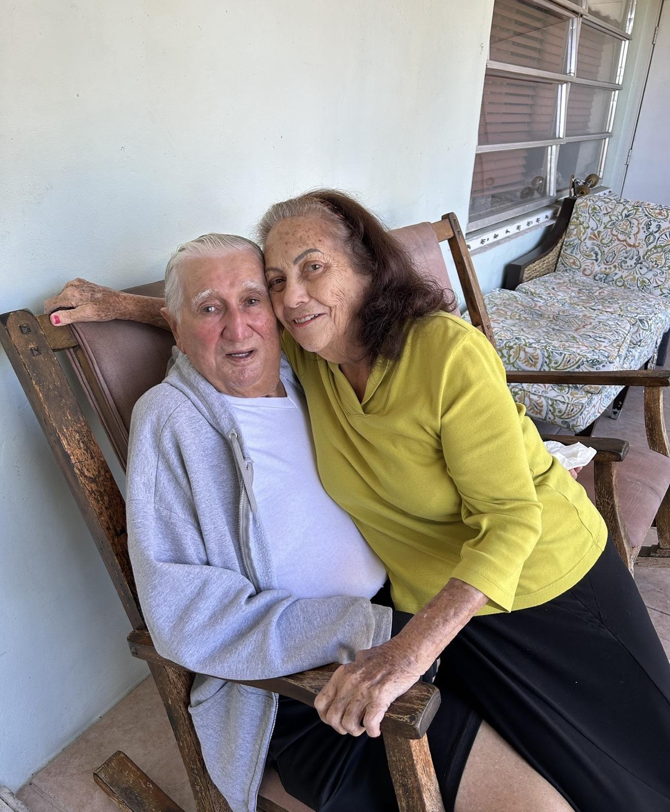 A man and woman sitting on a chair