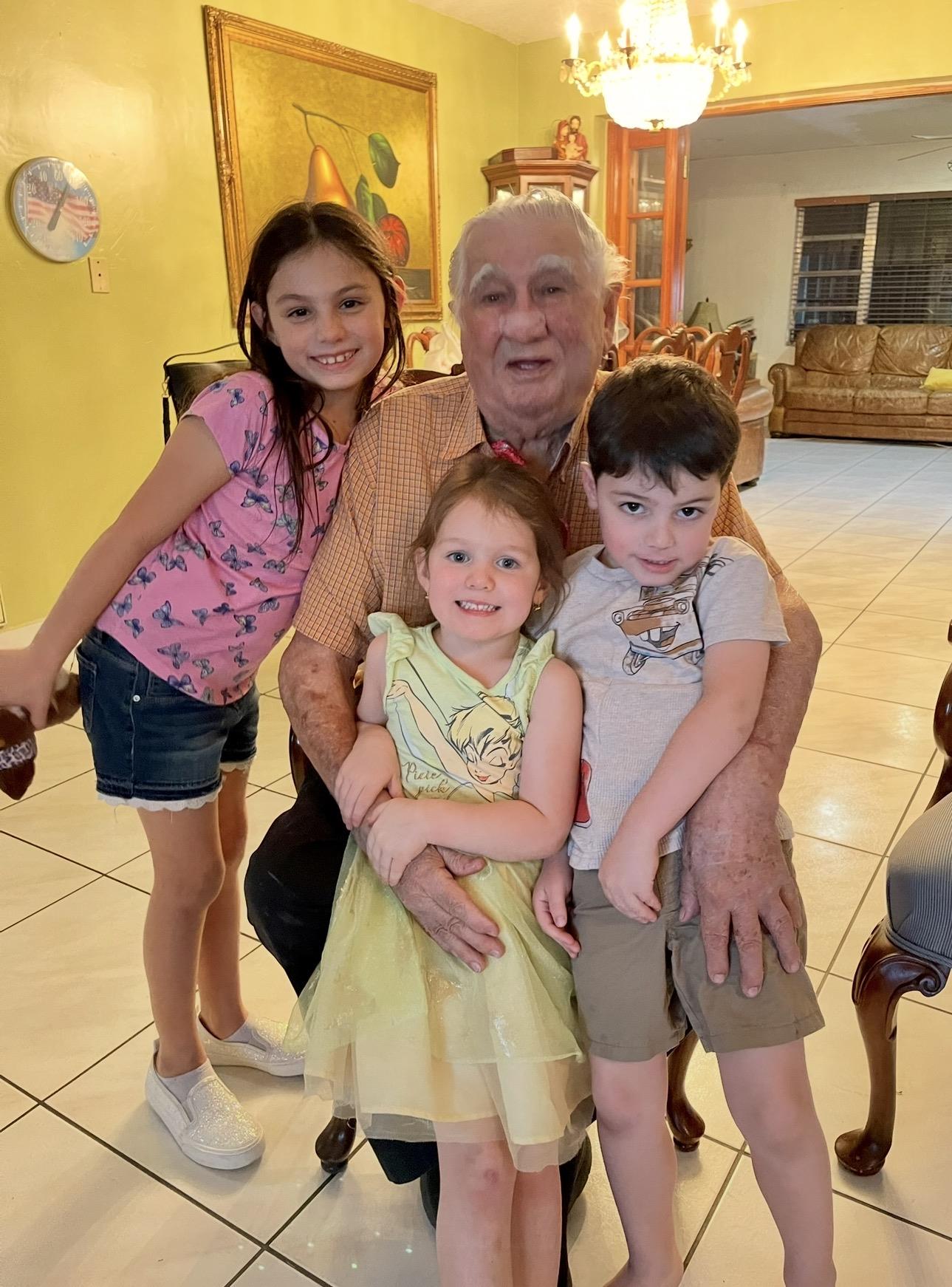 A man and children posing for a picture