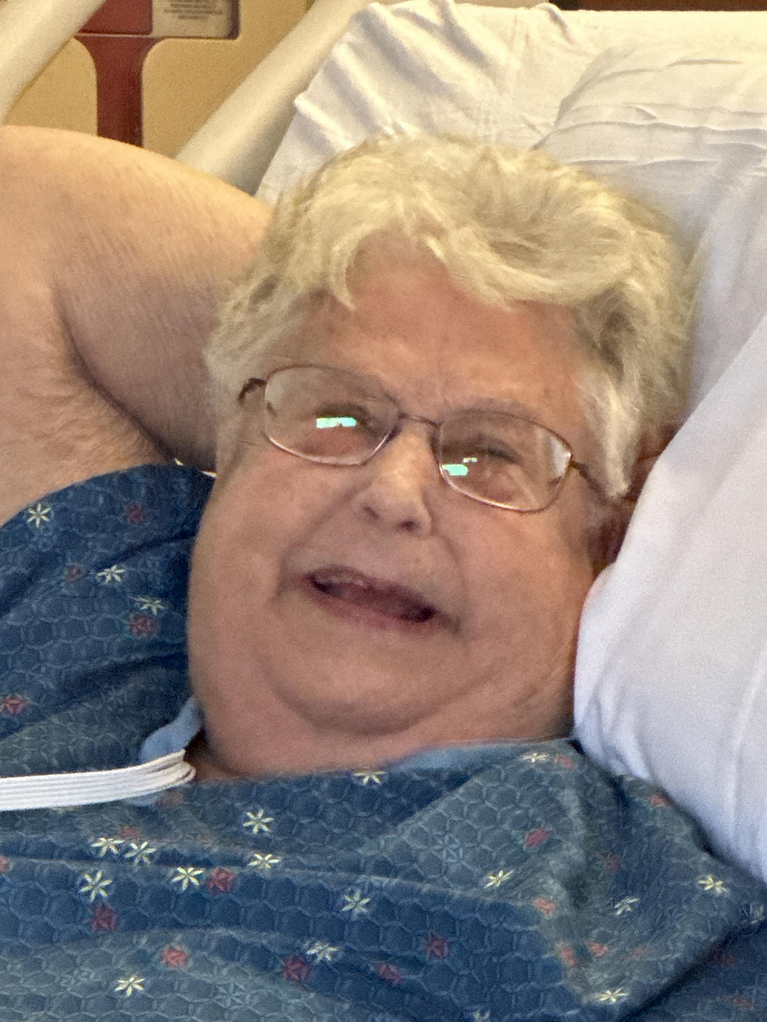 A person lying in a hospital bed