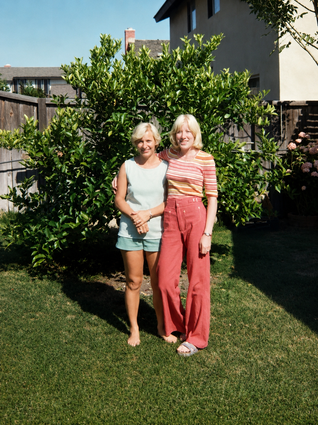 Two women standing in a yard