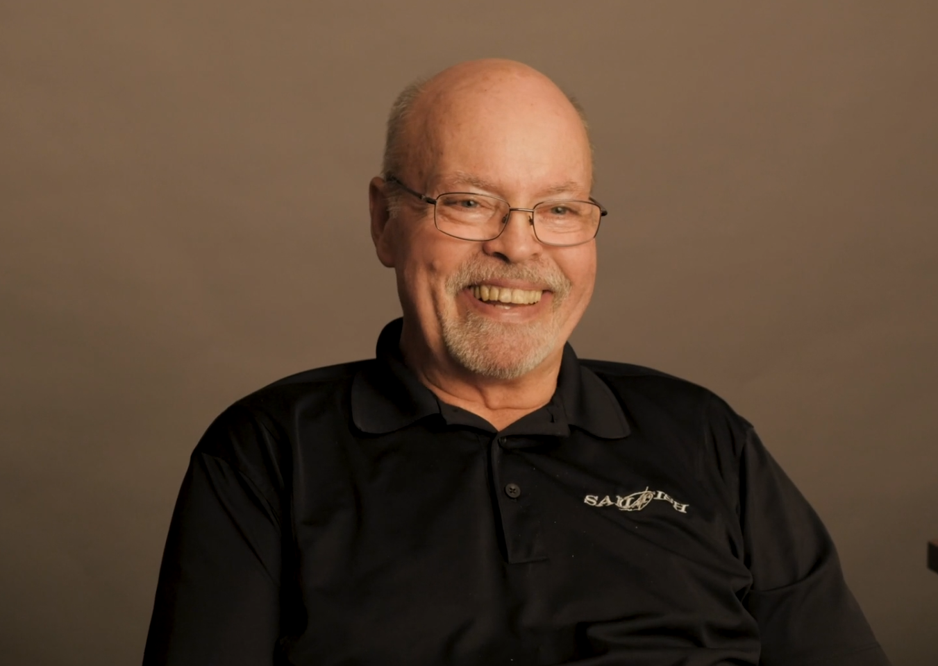 A man wearing glasses and a black shirt