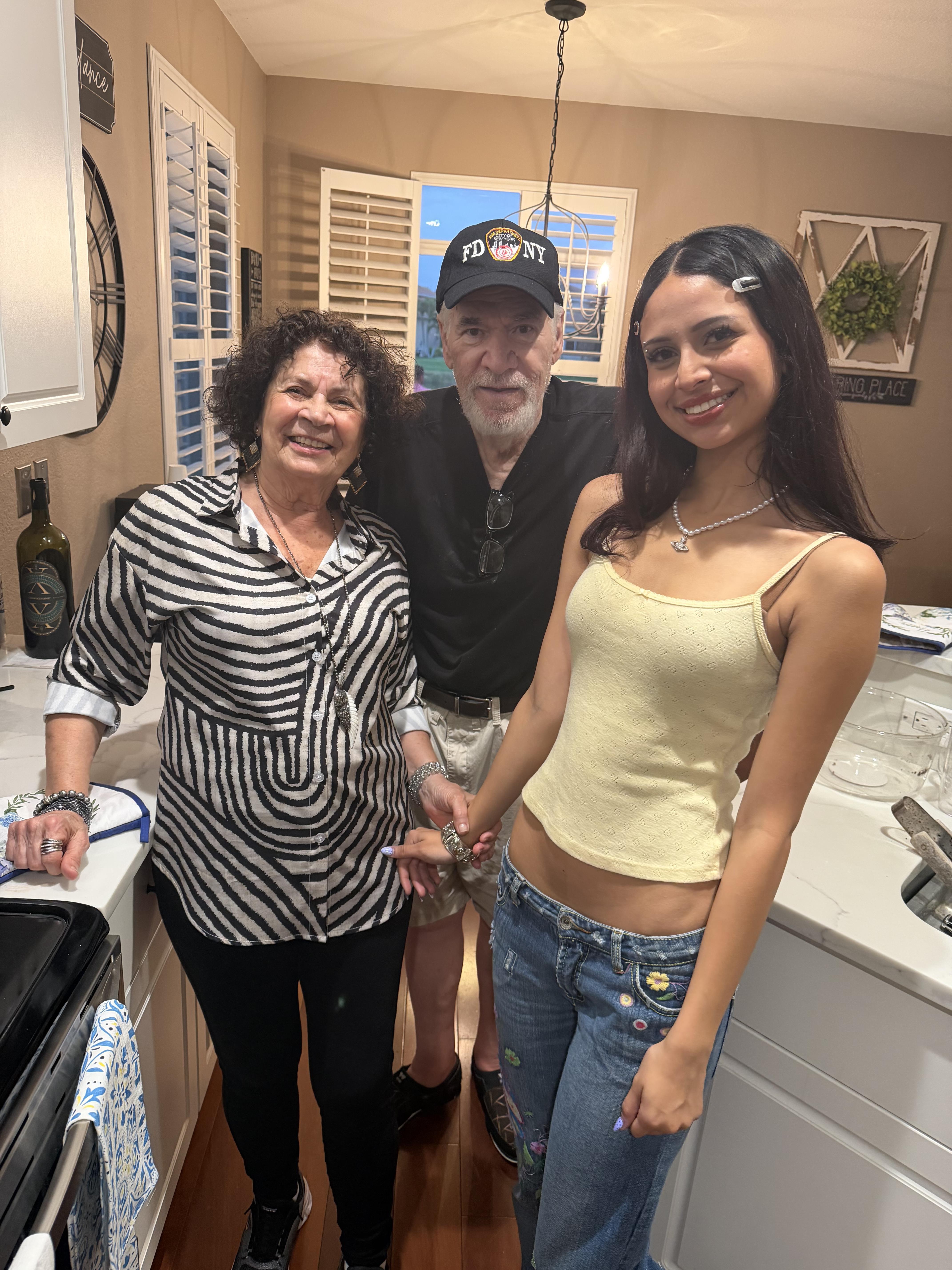 A group of people standing in a kitchen