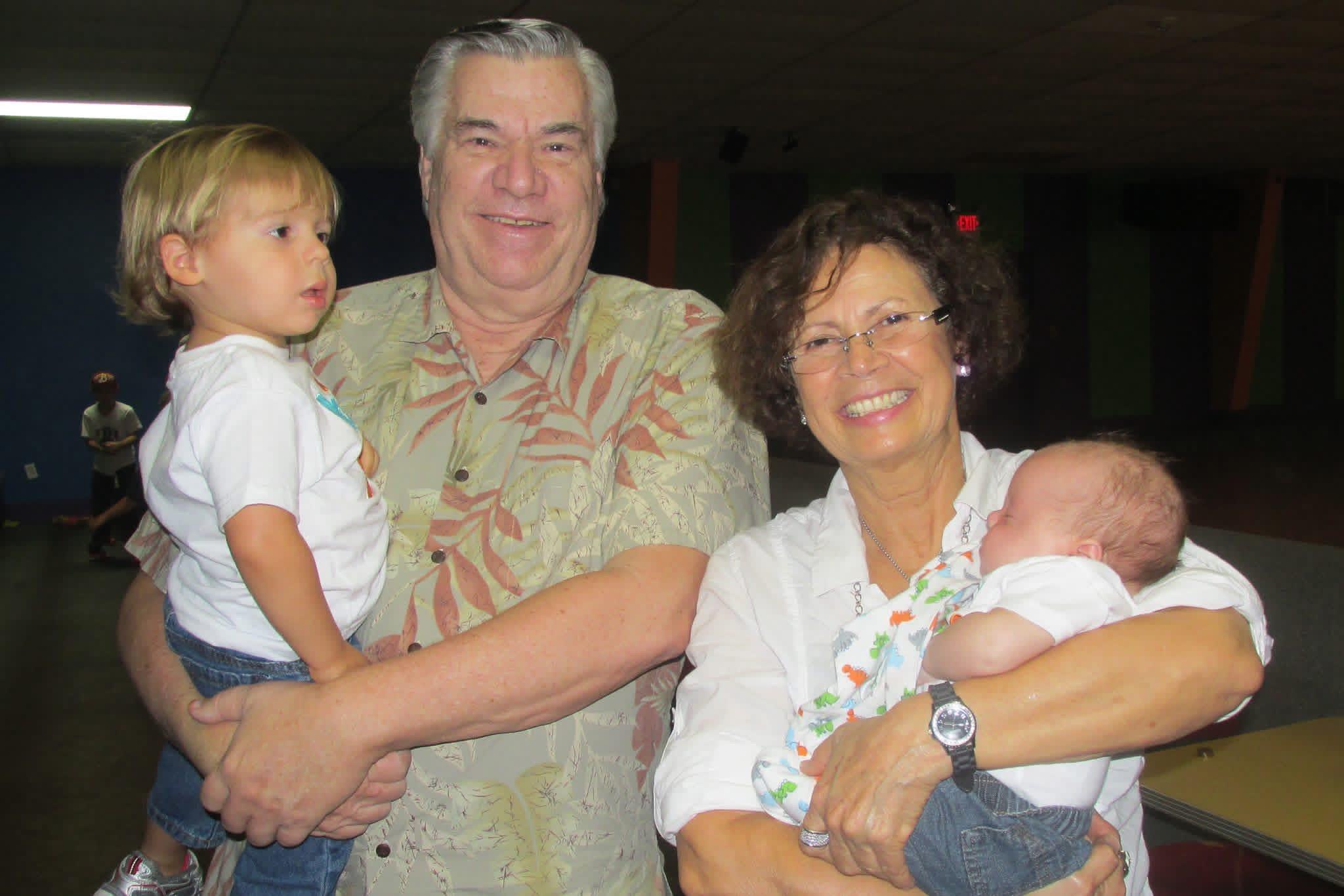 A man and woman holding babies
