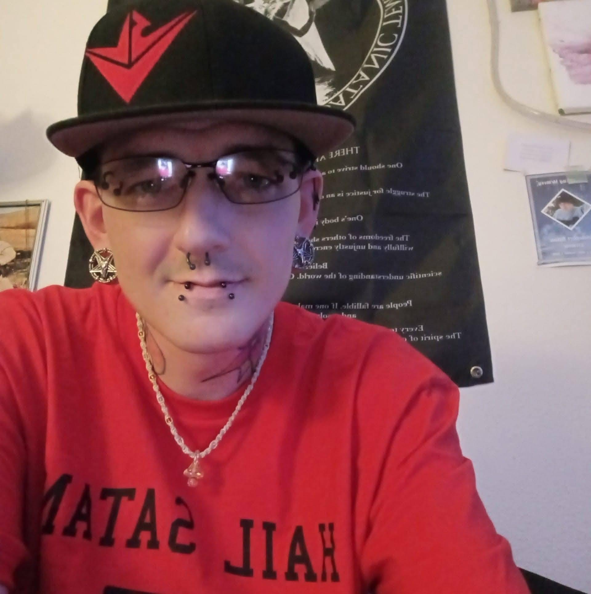 A man wearing a hat and glasses