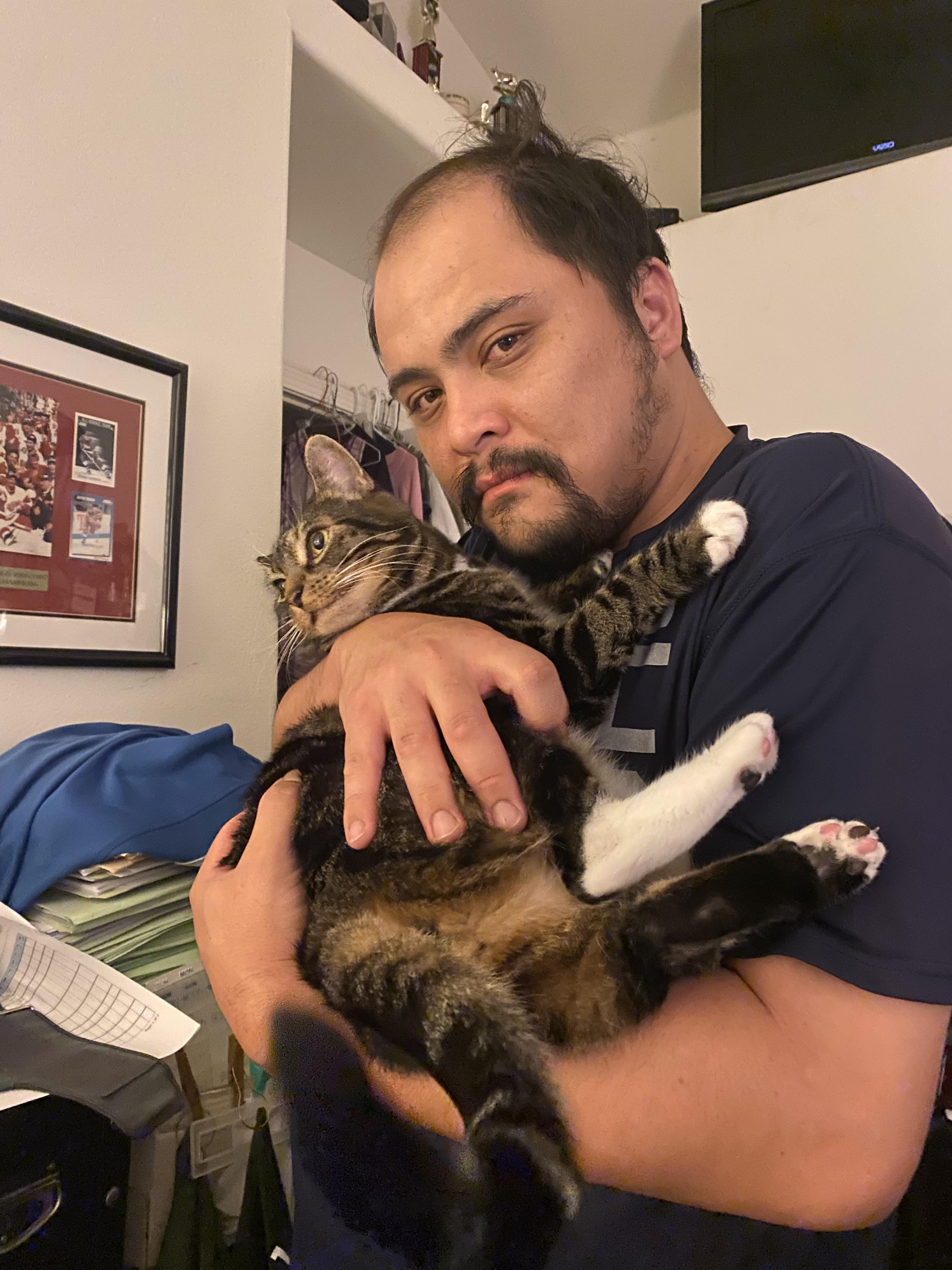 A man holding a cat