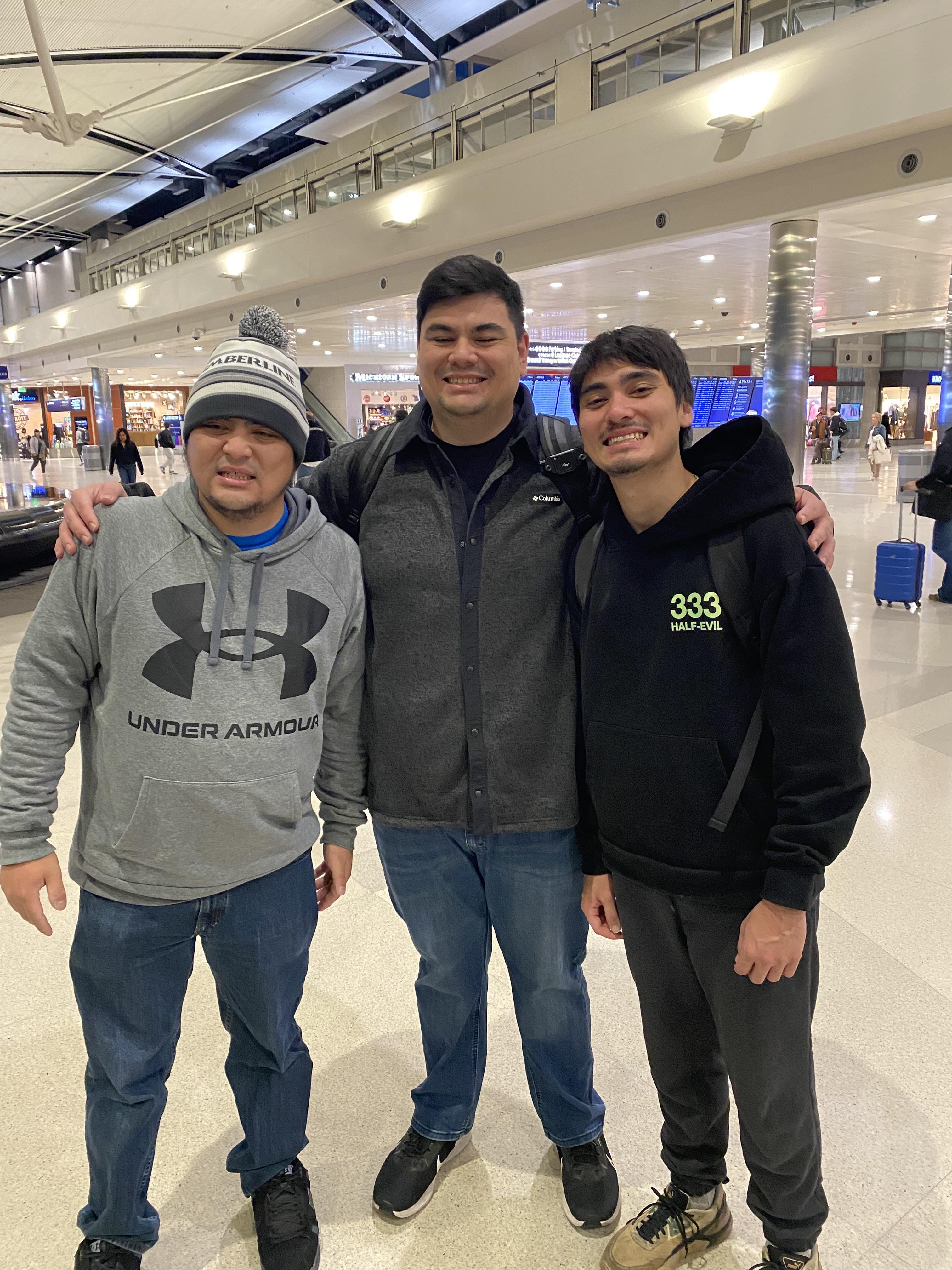 A group of men standing together in a mall