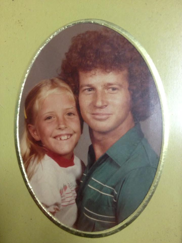 A man and a girl posing for a picture