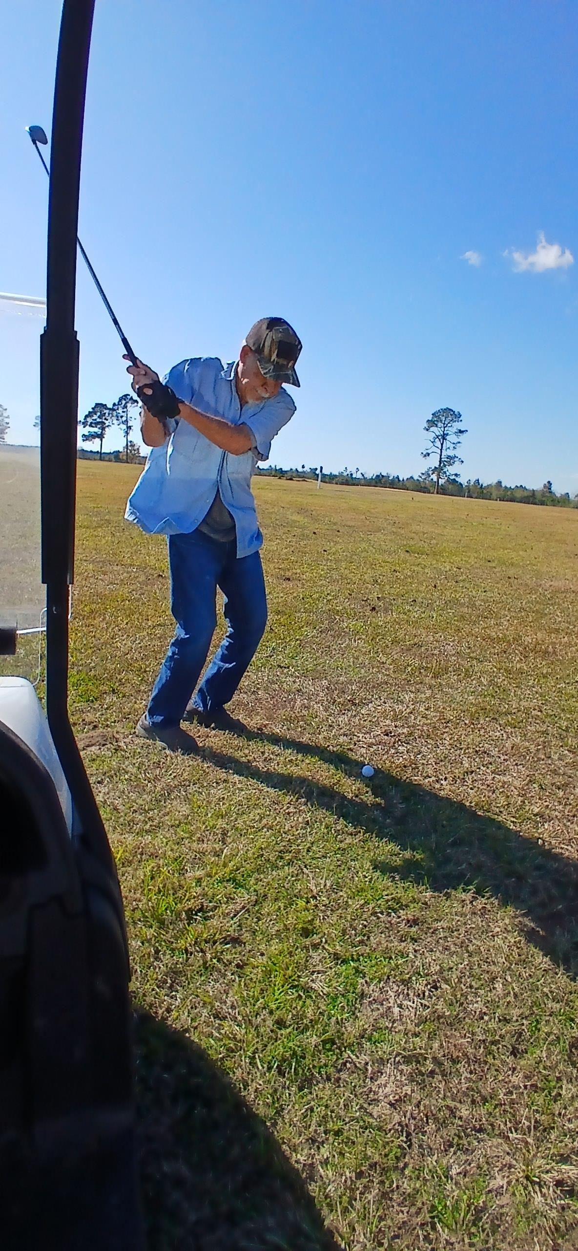 A man swinging a golf club