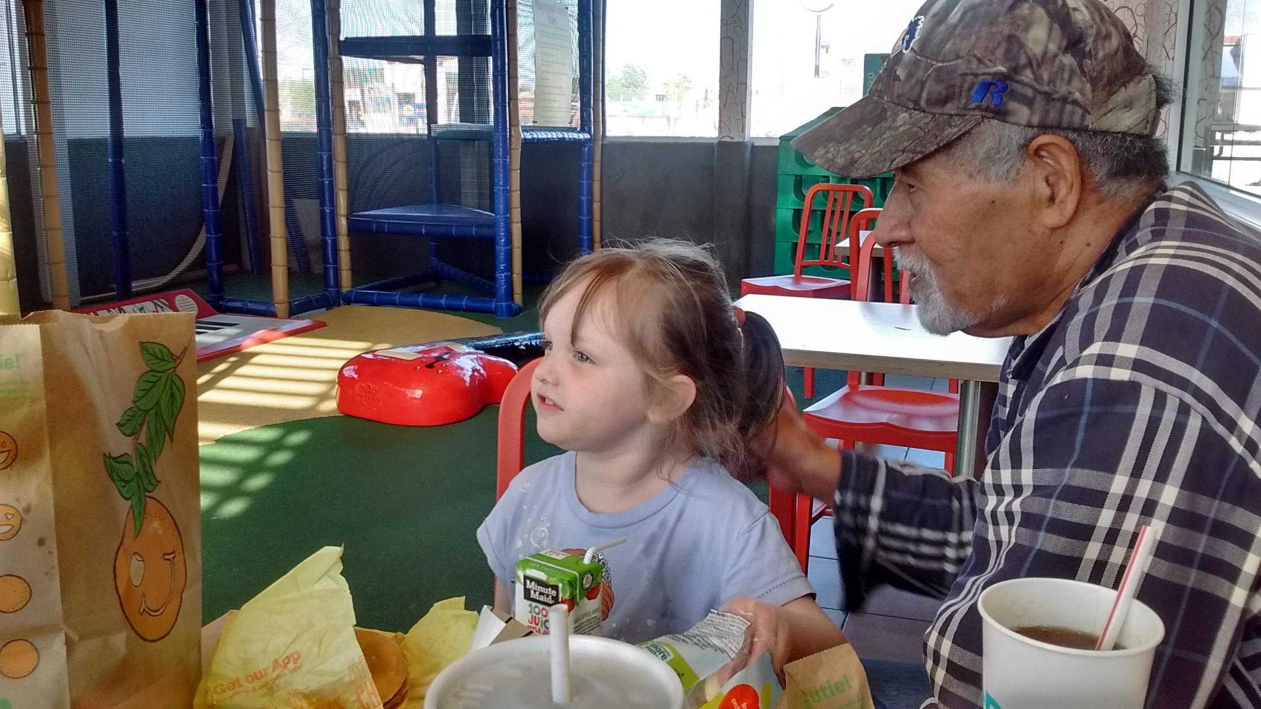 A man and a girl sitting at a table