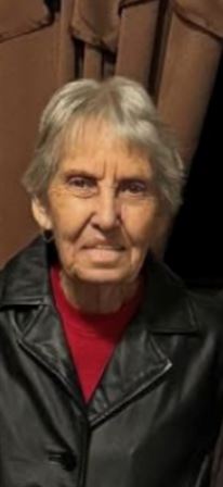 A woman with grey hair wearing a leather jacket