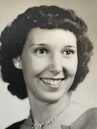 A woman with short dark hair smiling