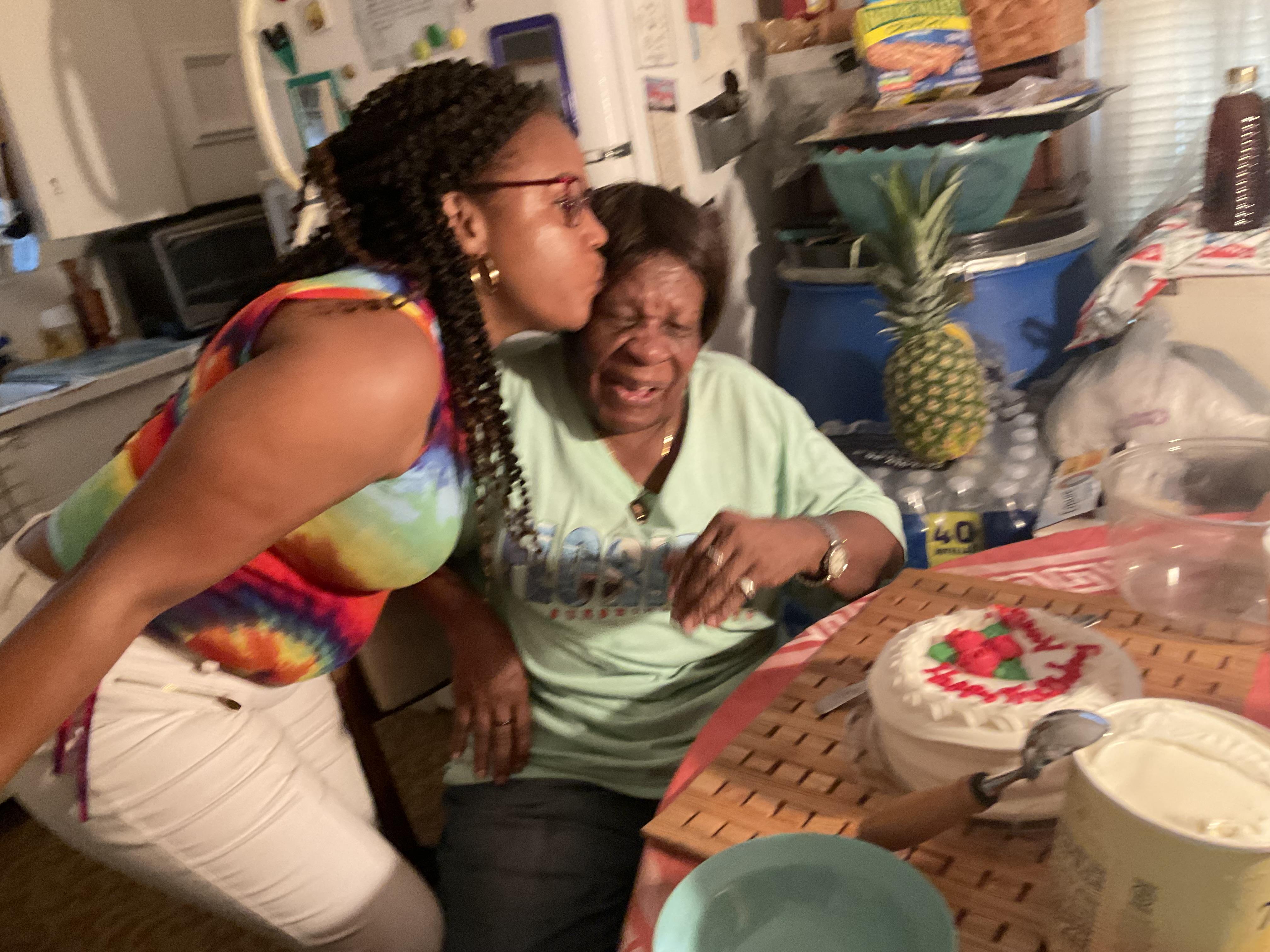 A woman kissing another woman's cheek