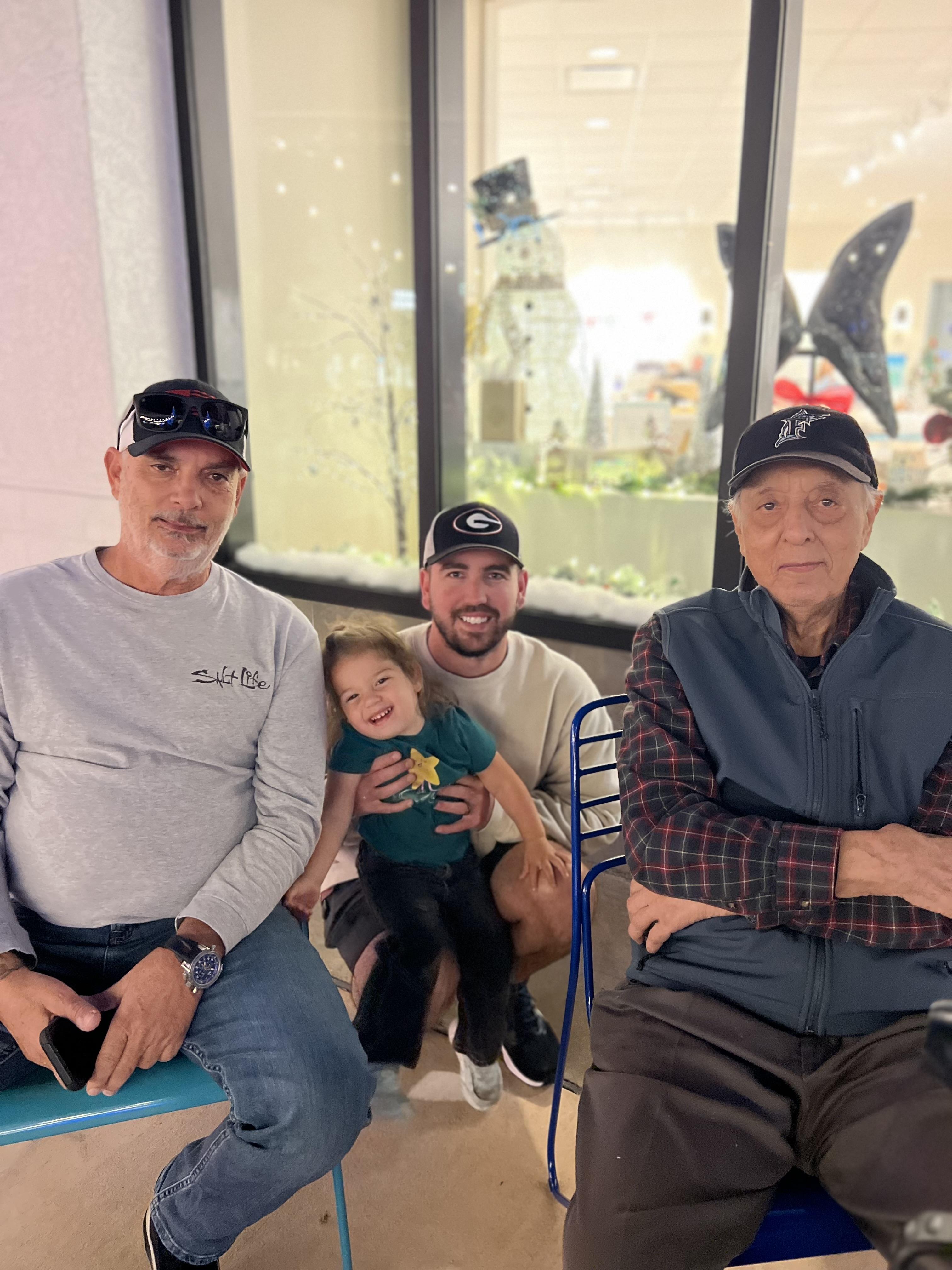 A group of men and a child posing for a photo