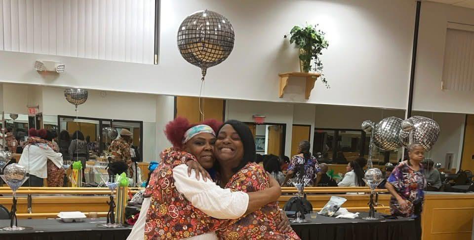 Two women hugging each other