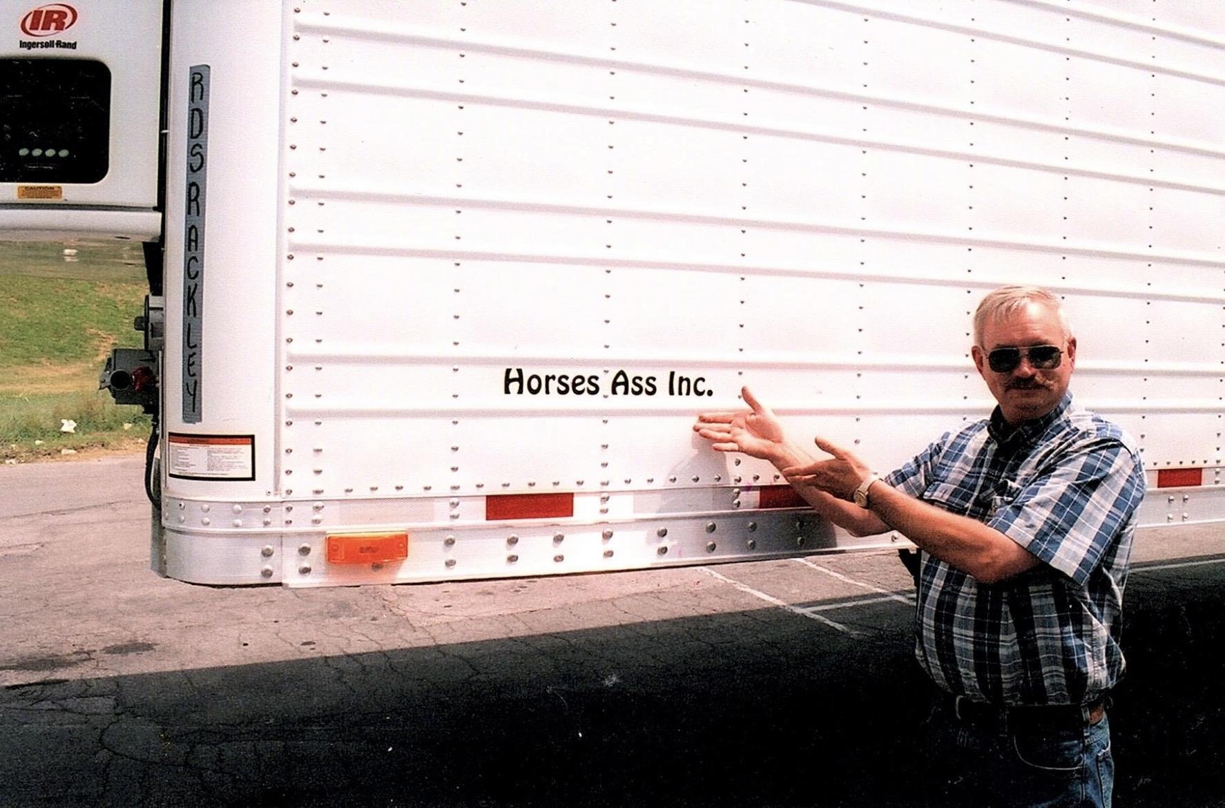 A man standing next to a white truck