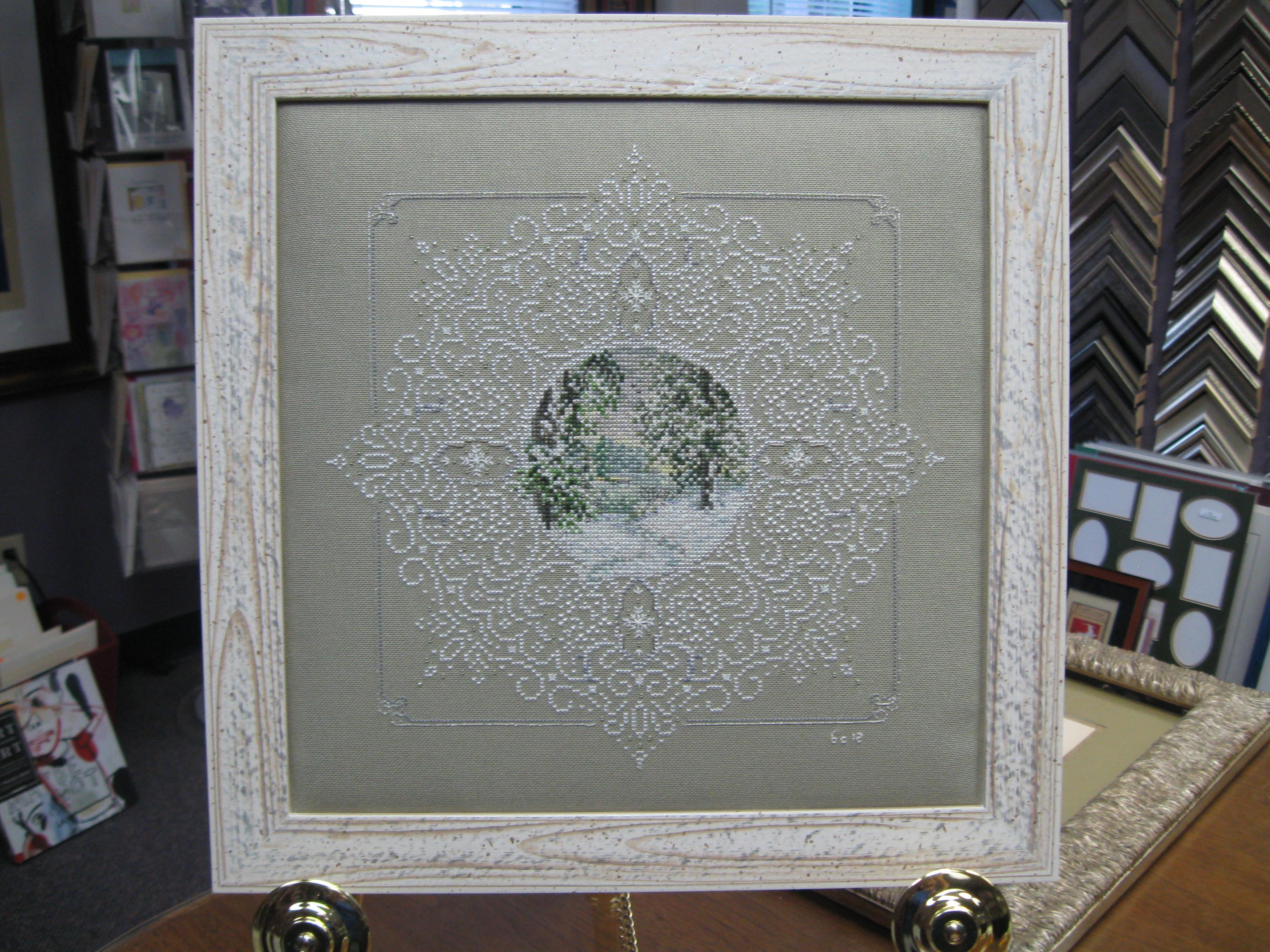 A white framed picture with a circular design