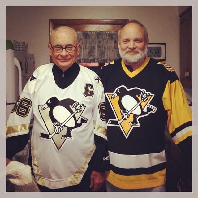 Two men wearing hockey jerseys
