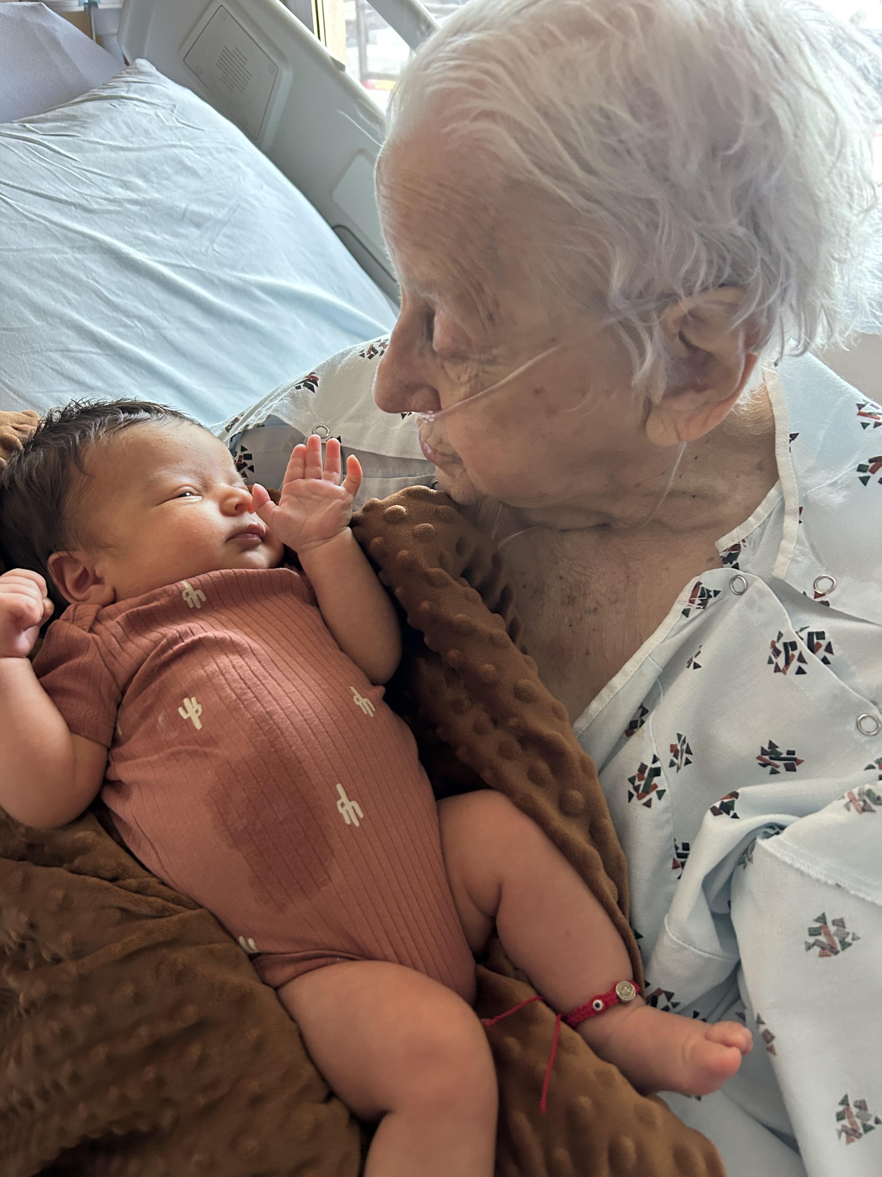 An old woman holding a baby