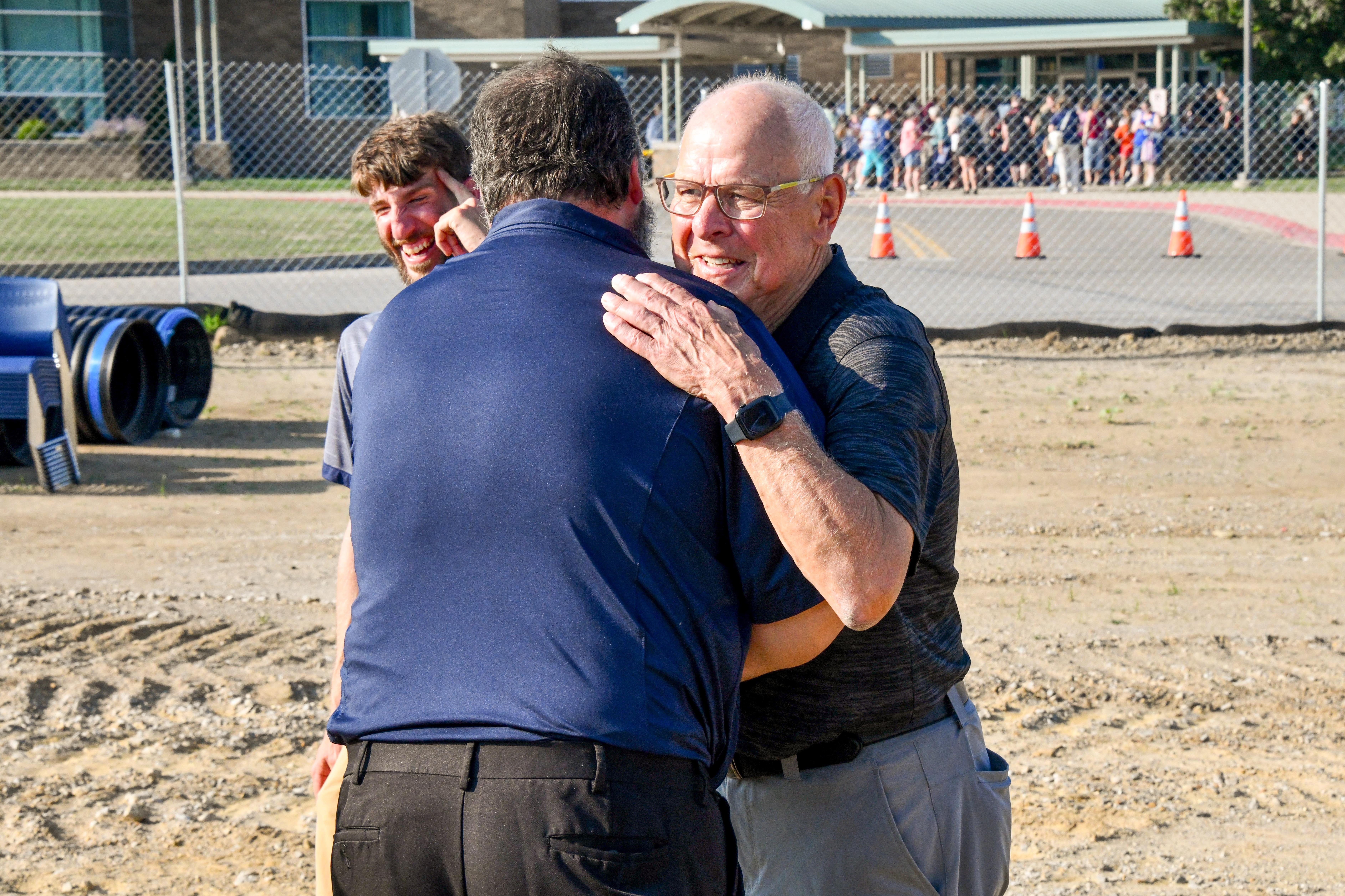 Two men hugging each other