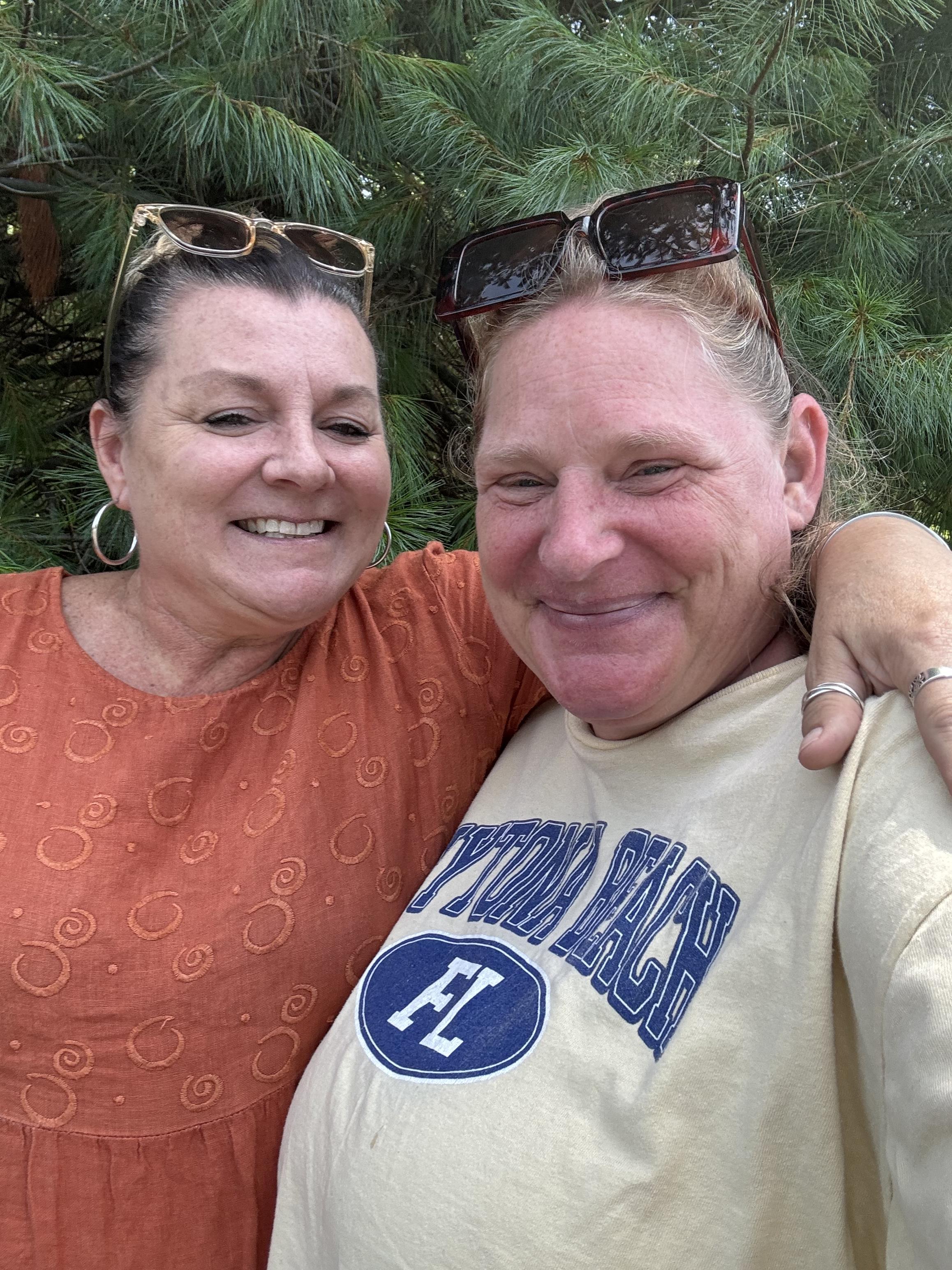A couple of women smiling and taking a selfie