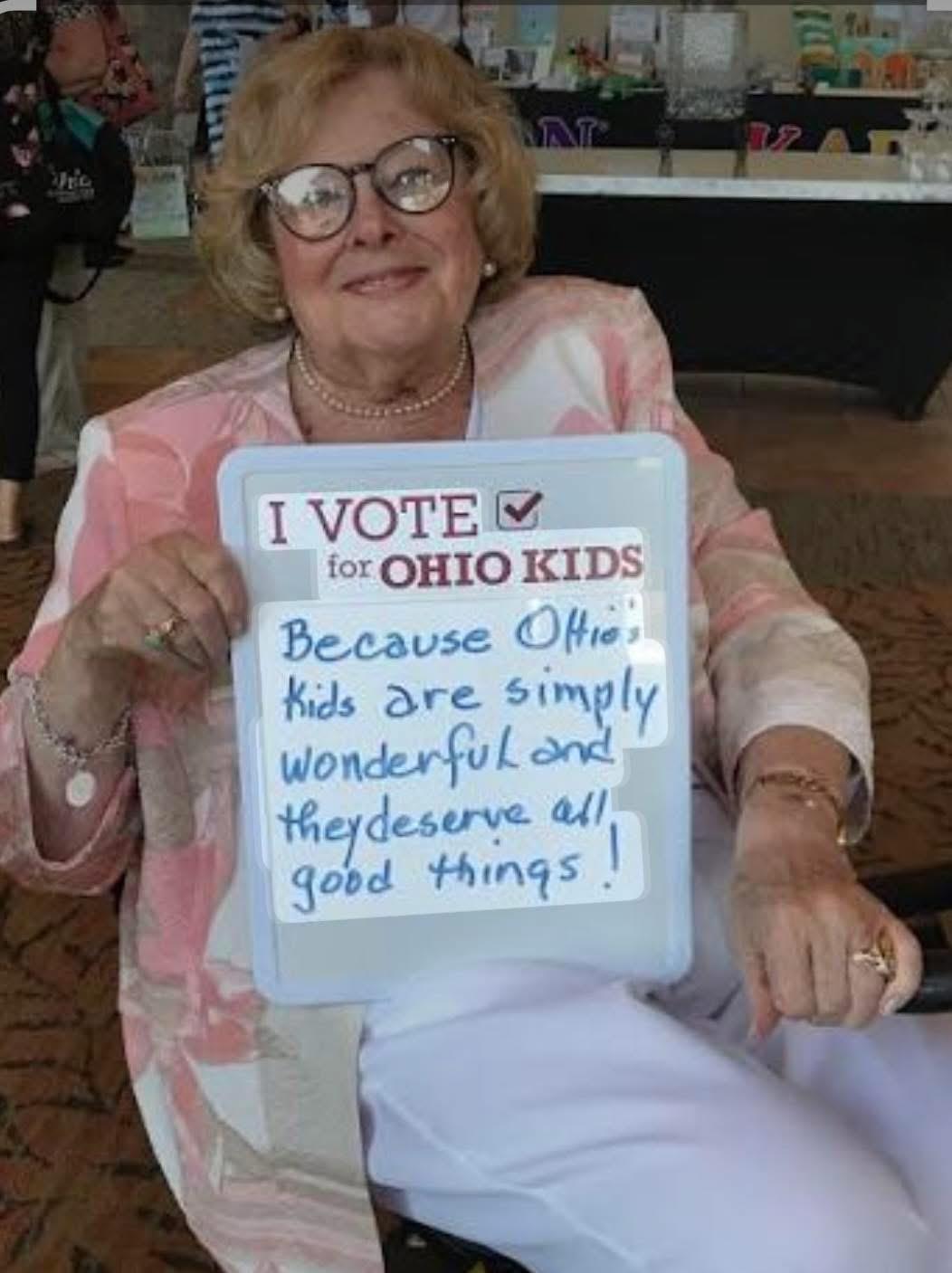 A woman holding a sign
