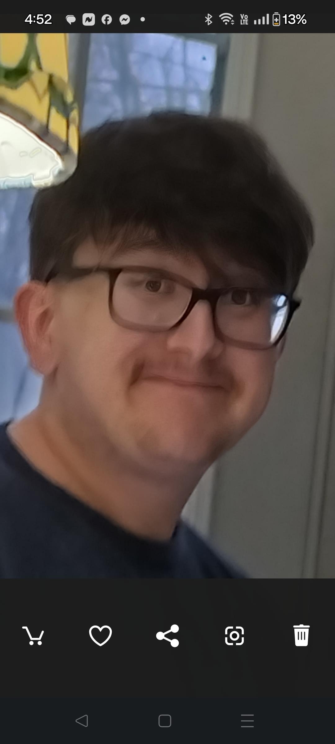A man wearing glasses smiling