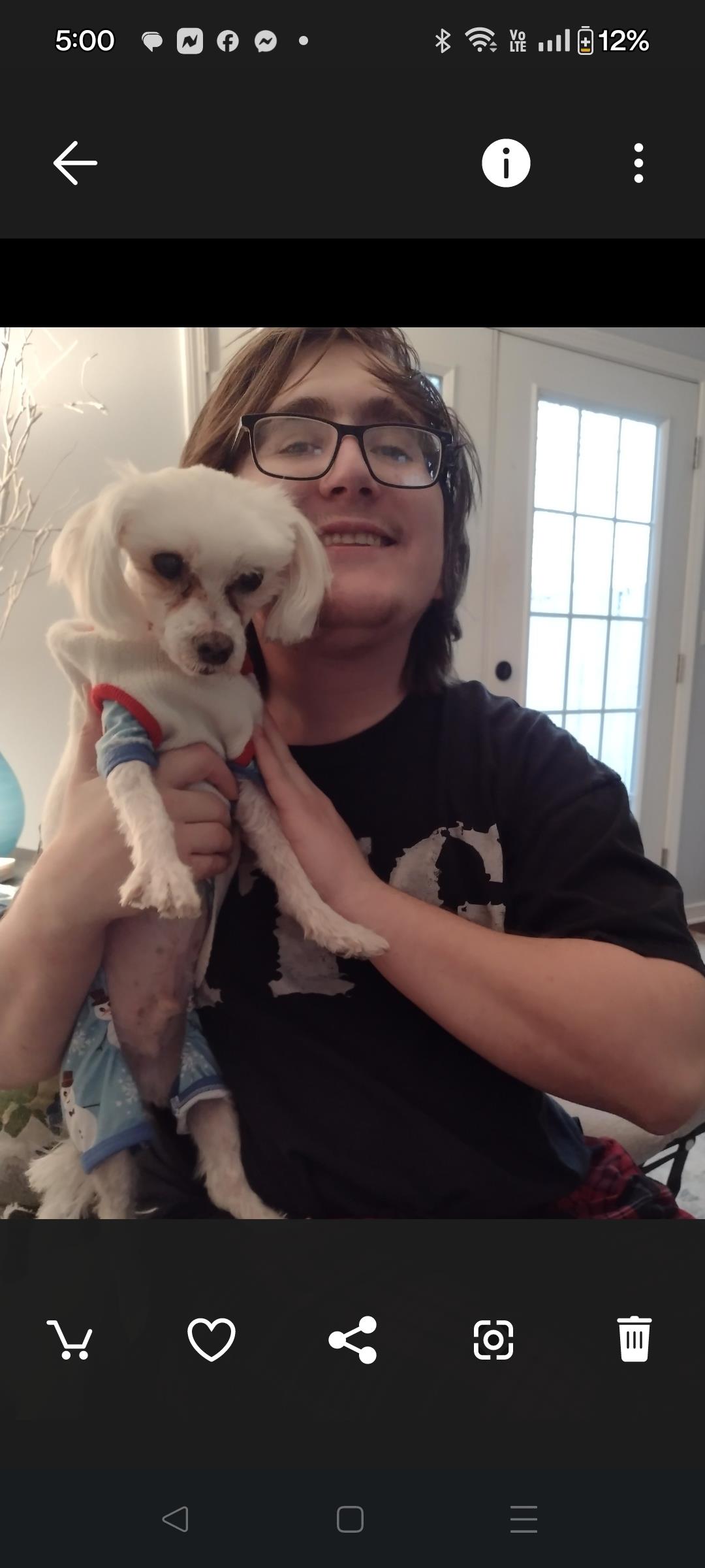 A man holding a dog