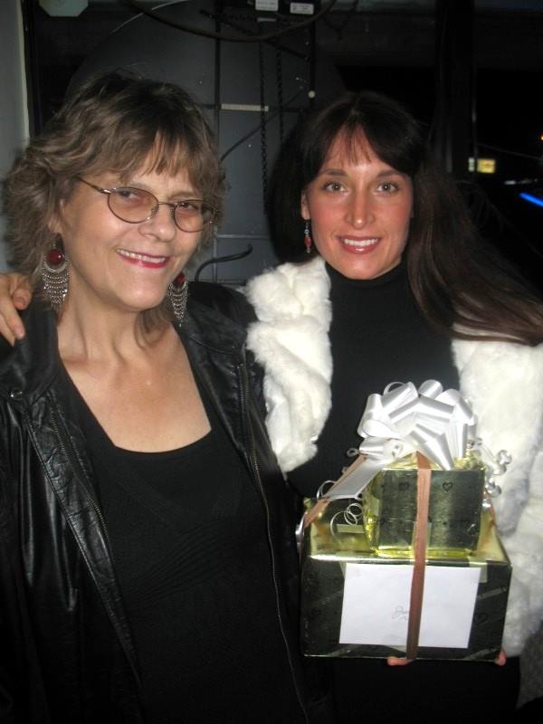 Two women holding a gift