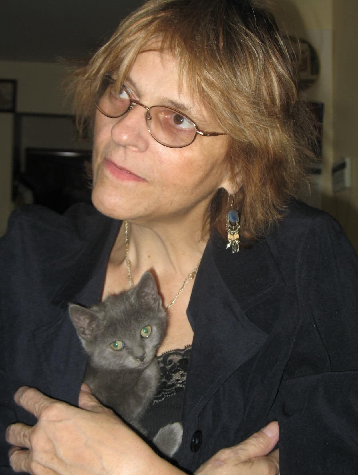A woman holding a kitten