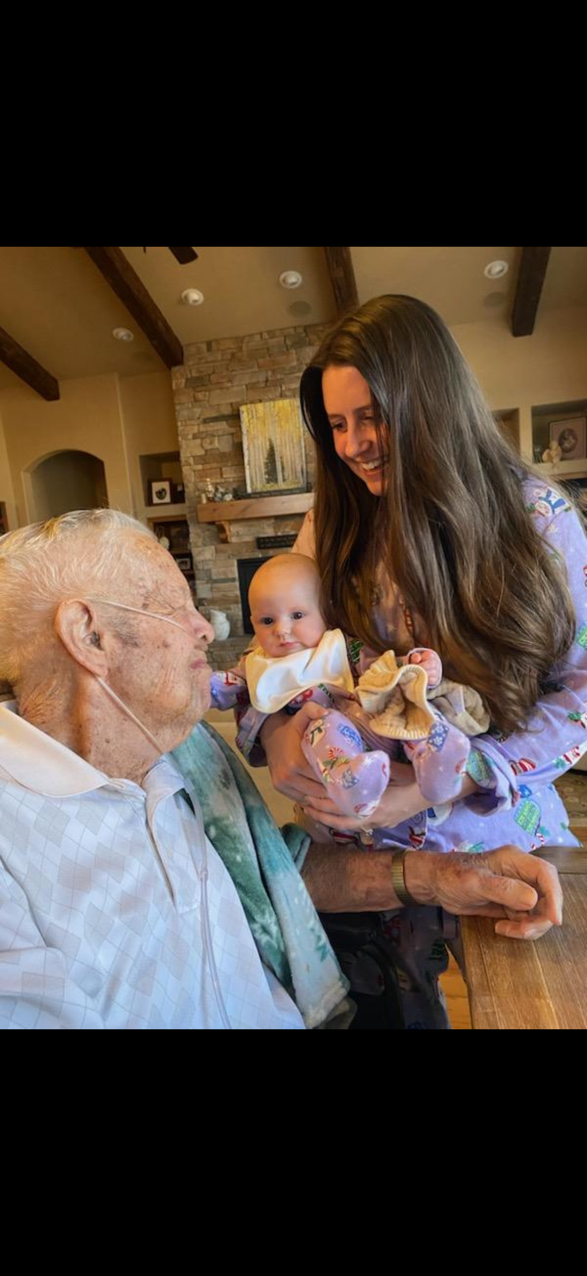 A woman holding a baby and a man