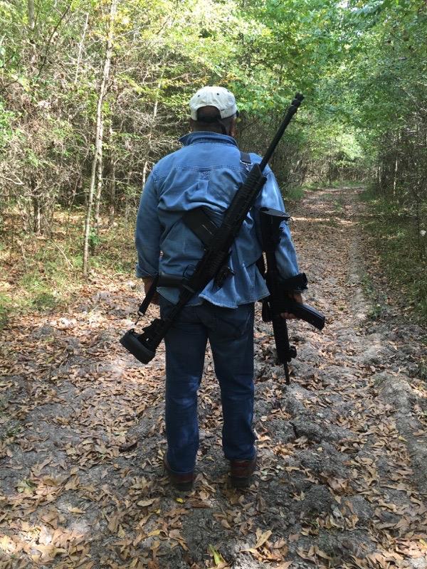 A man with a gun on his back