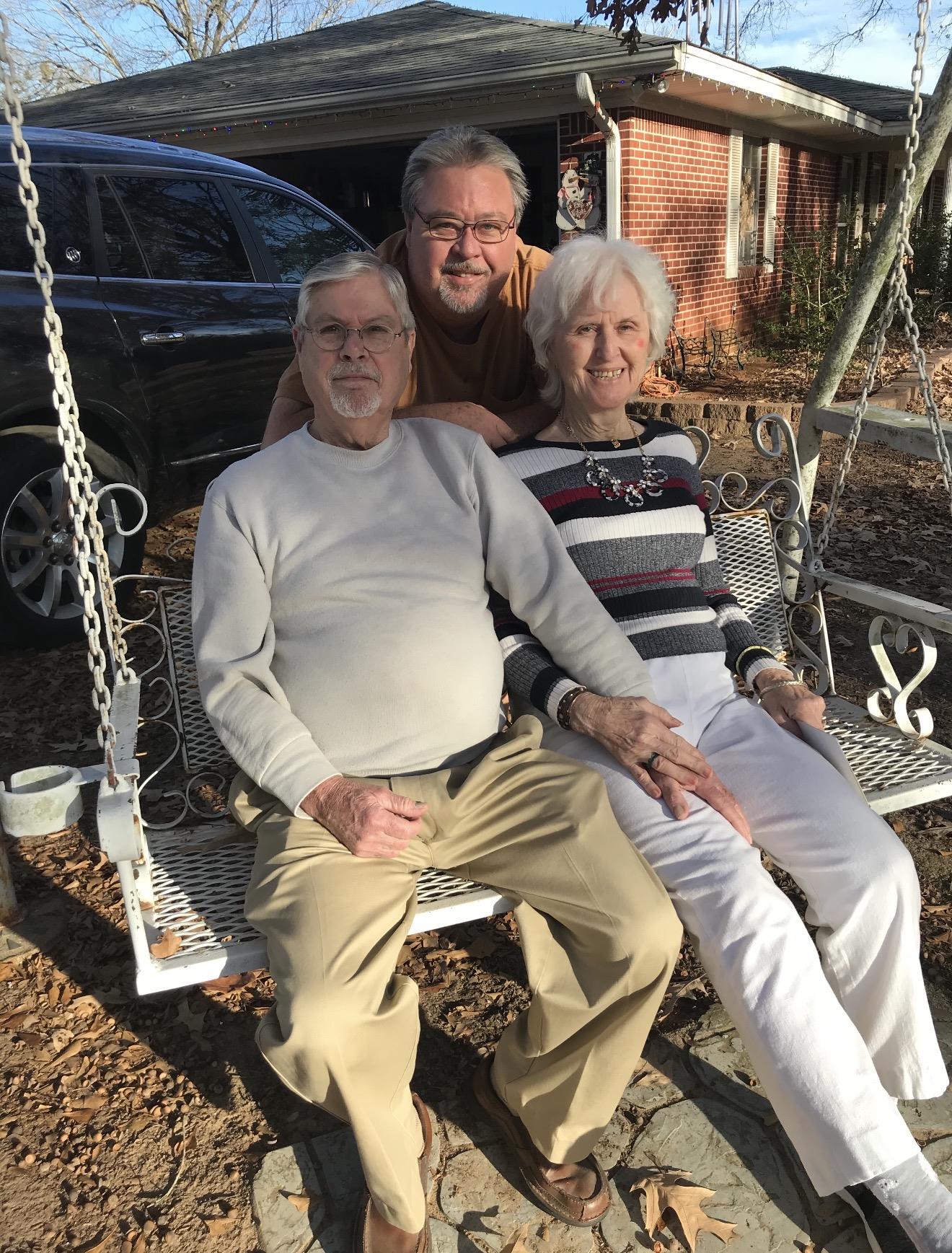 A group of people sitting on a swing