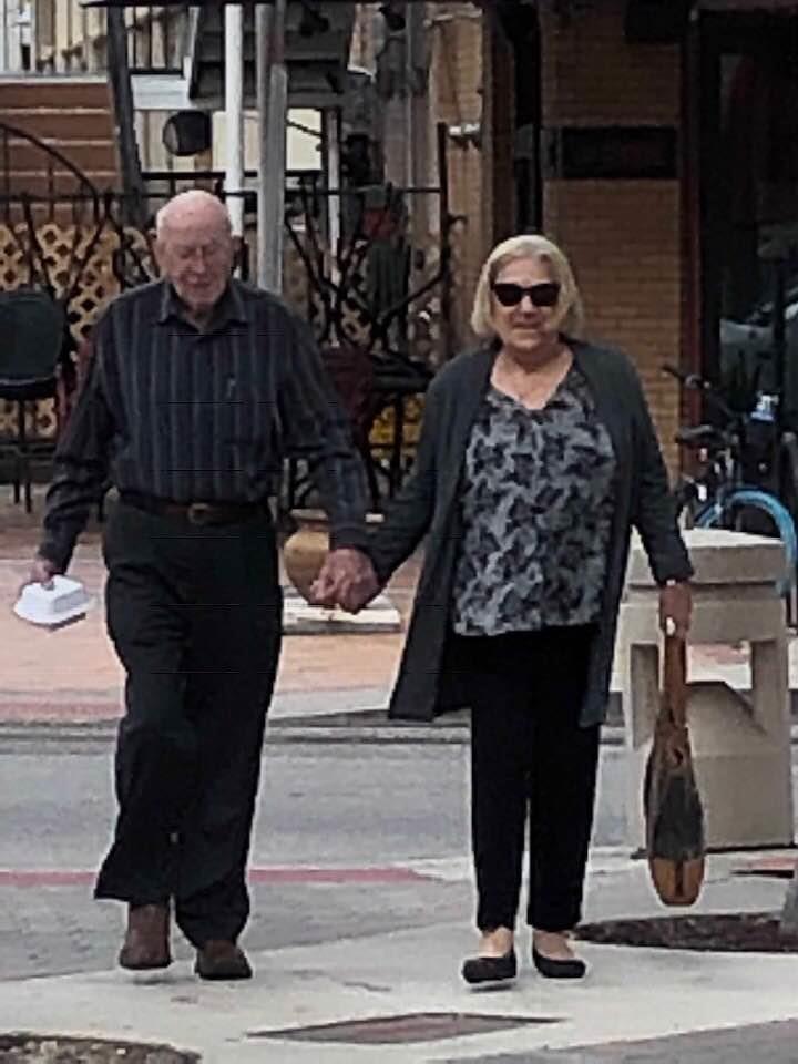 A man and woman holding hands