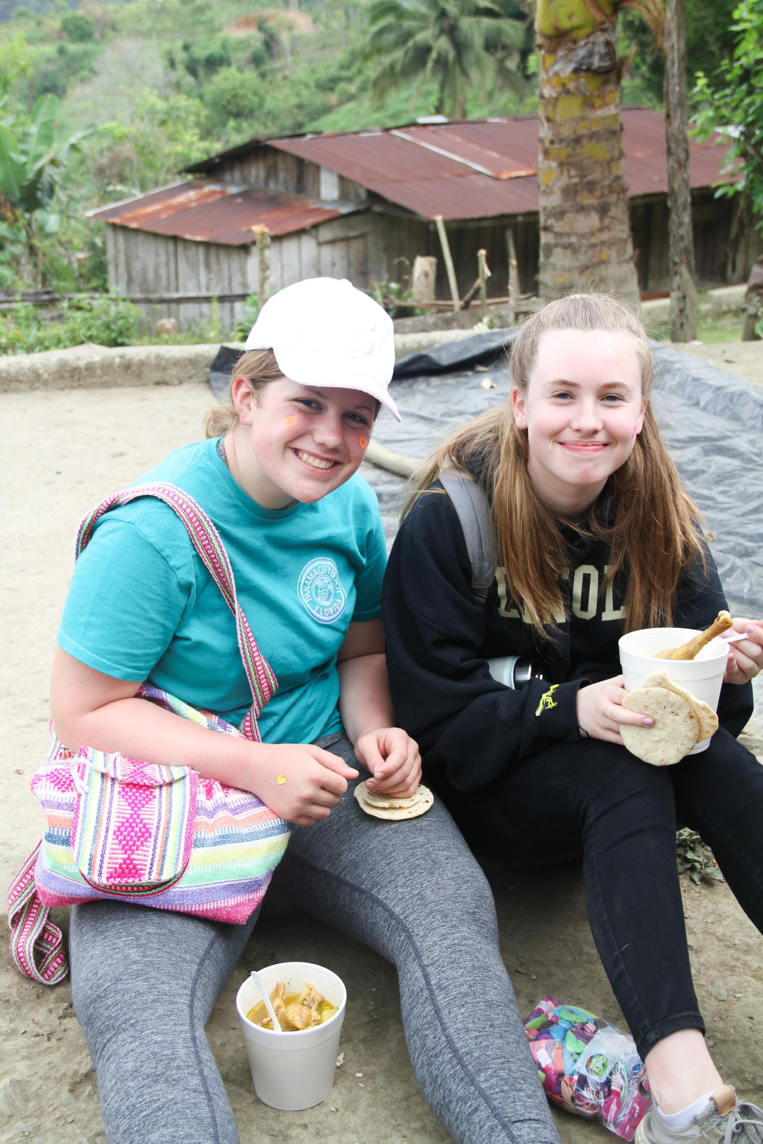 Two girls sitting on the ground